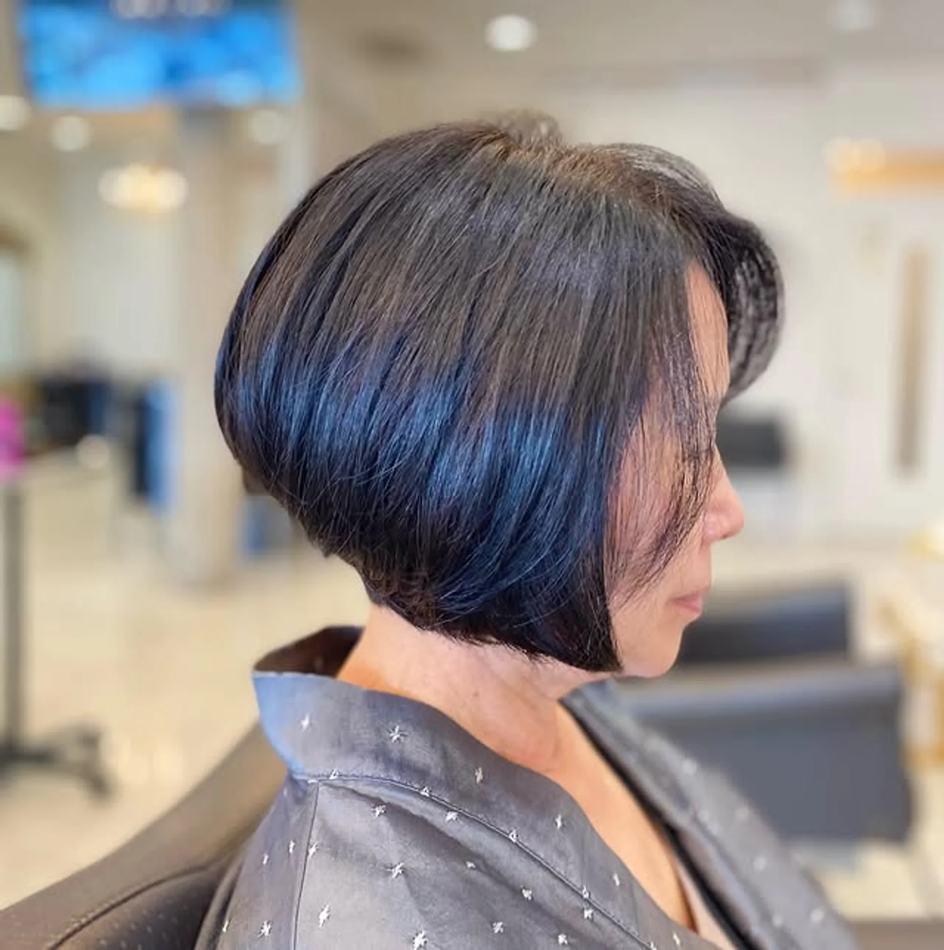 Sleek chin-length graduated bob haircut, polished and stylish - Preview 1