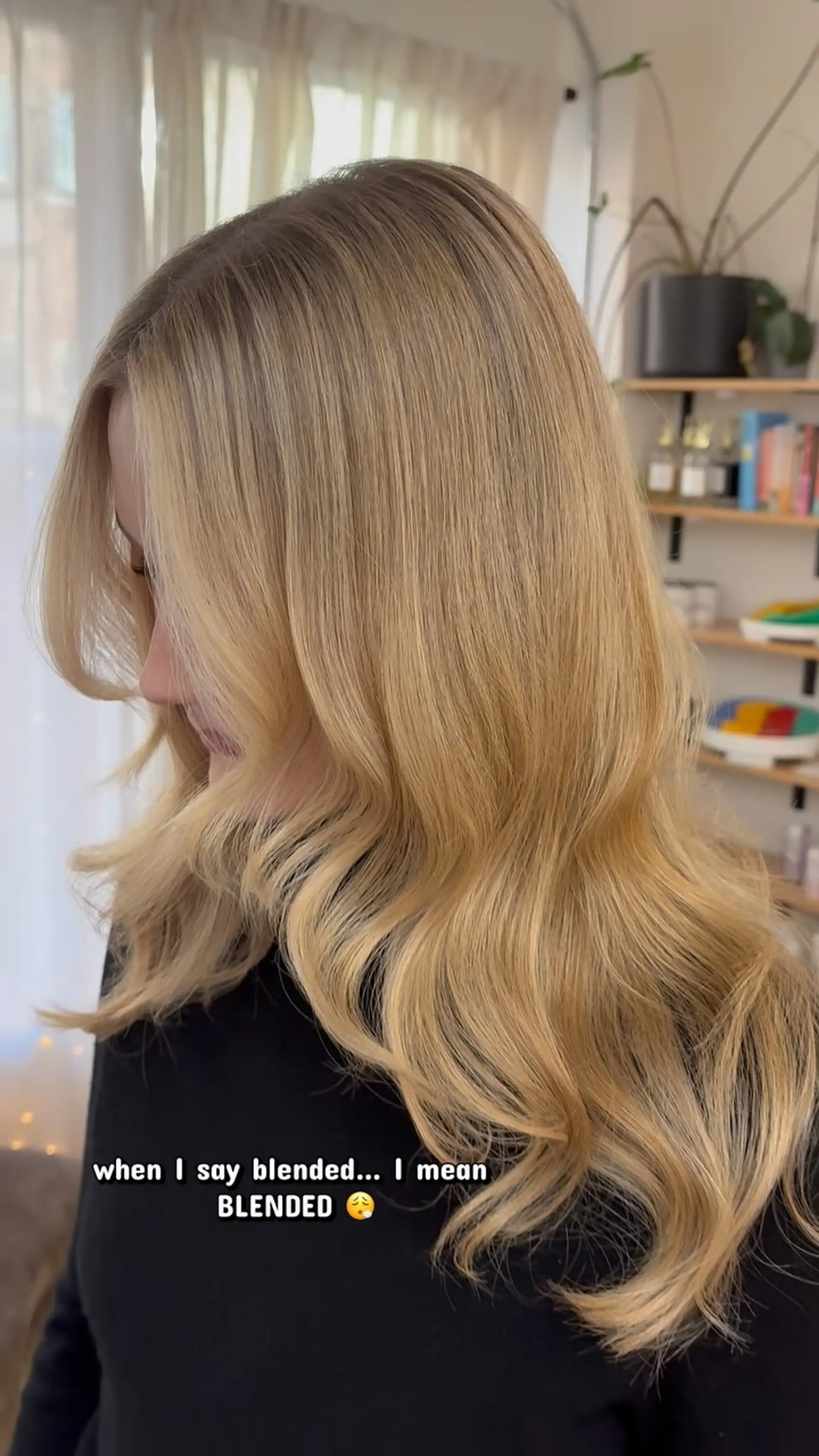 Seamlessly blended warm golden blonde color styled with soft, cascading loose waves and face-framing layers. 1