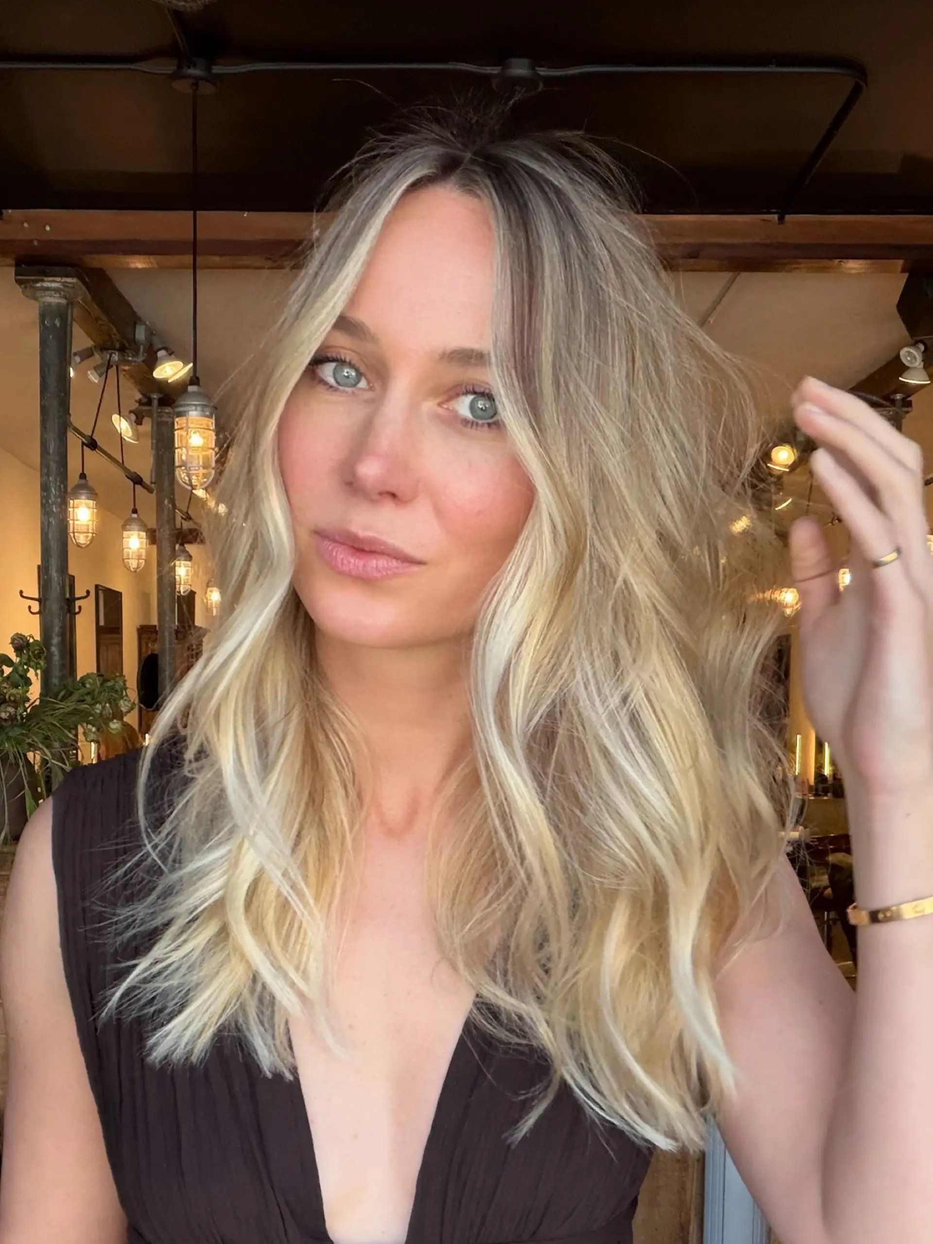 Dimensional sun-kissed blonde highlights with luminous face-framing strands styled into soft, tousled waves. 1