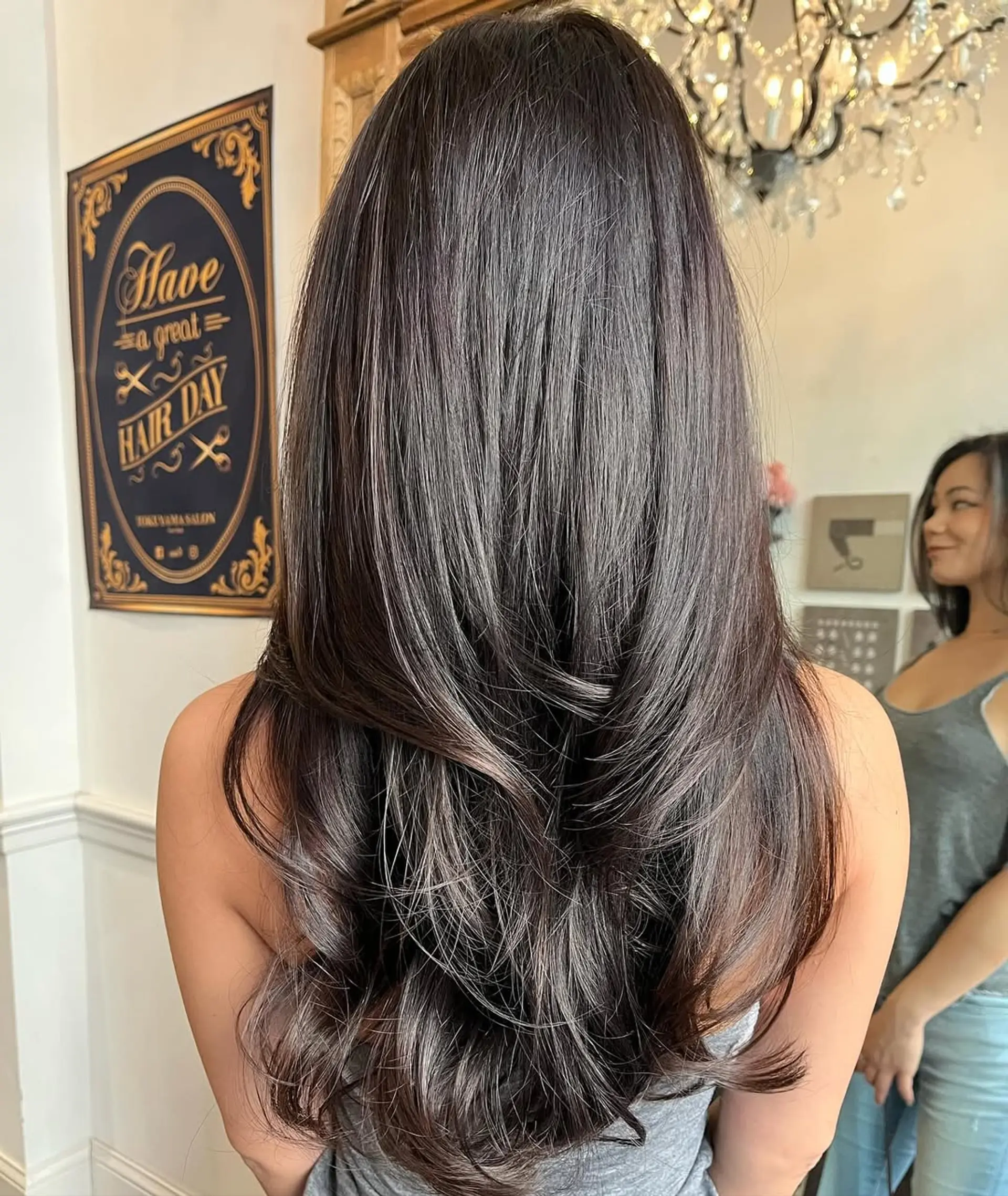 Long dark brown hair with soft waves and subtle layered ends creating a luxurious and elegant look. 2