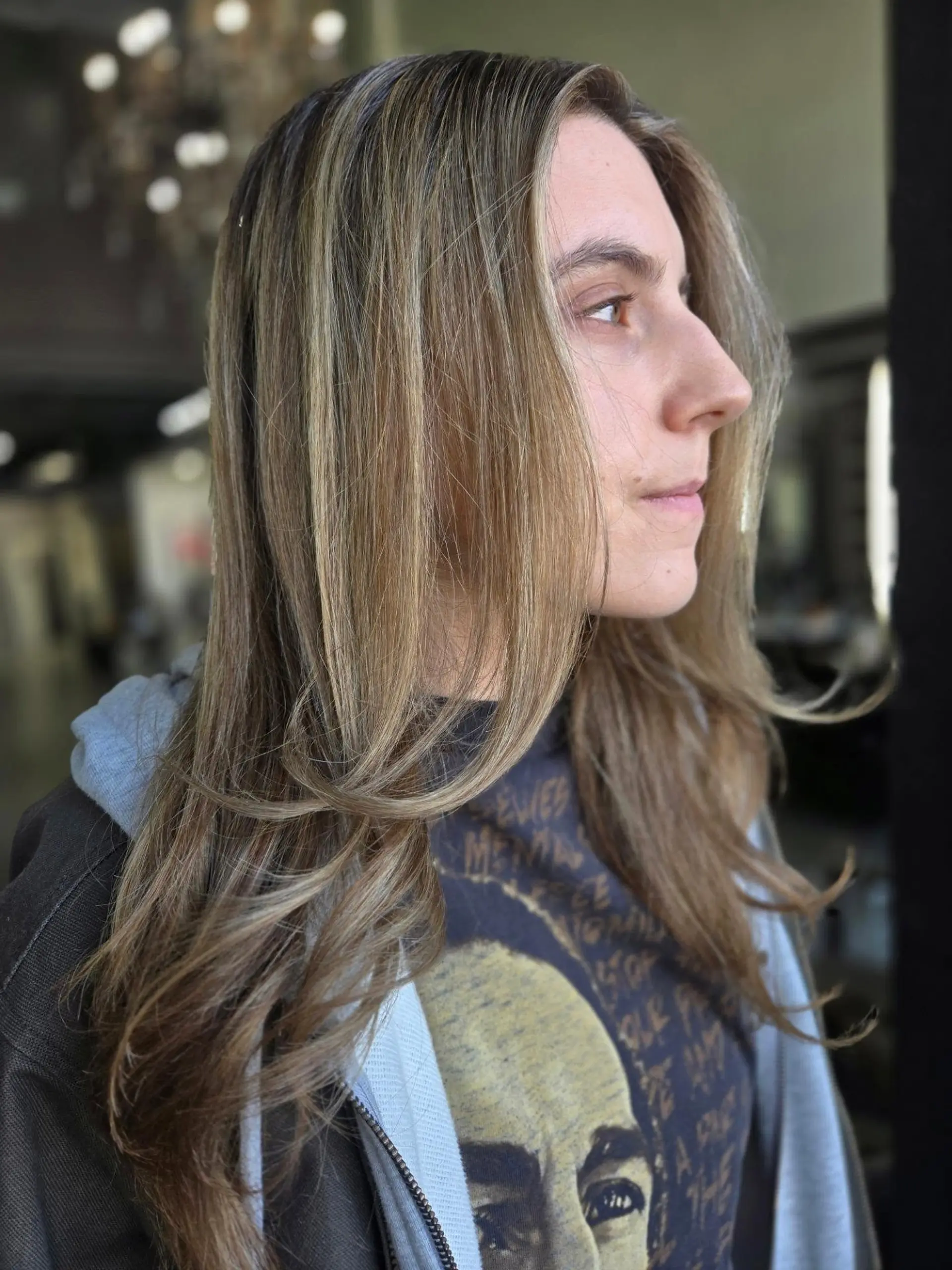 Long layered light brown hair featuring soft blonde sombré highlights and a gentle face-framing money piece. 1