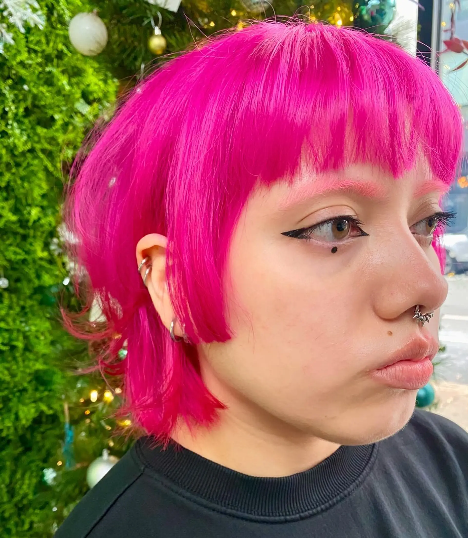 A short, layered bob with blunt bangs. 2