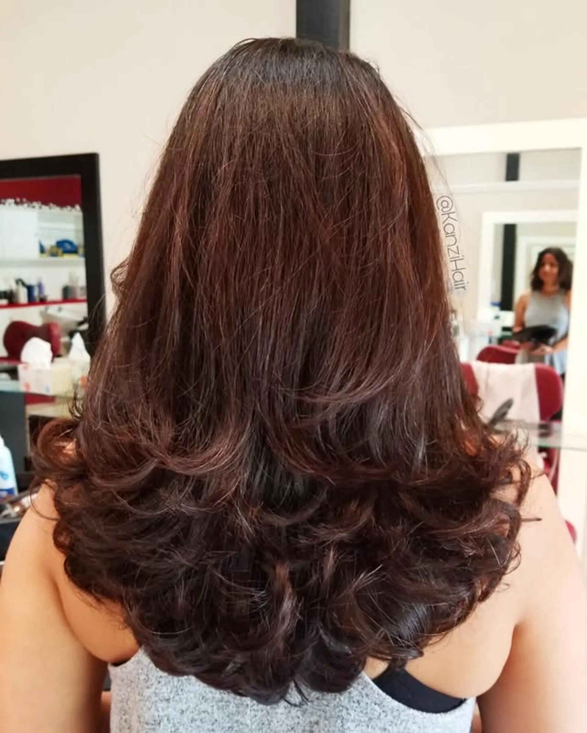 This voluminous U-cut features long, bouncy layers that create a feathered effect and soft, curled ends. The expertly cut layers add significant body and movement, framing the back beautifully and providing a plush, full finish. 1