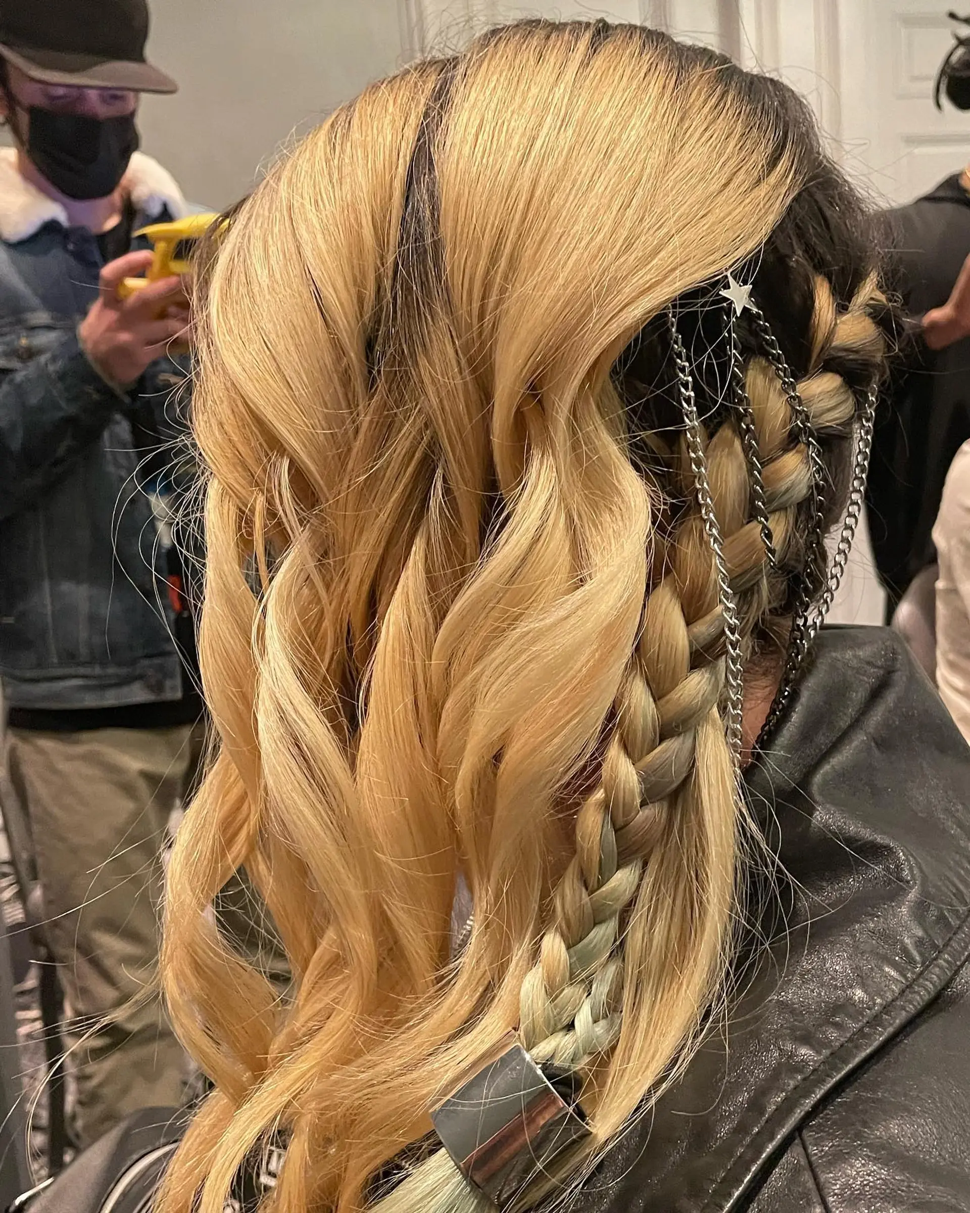 A bold event hairstyle featuring loose golden blonde waves paired with side accent braids woven with metallic chains. 1