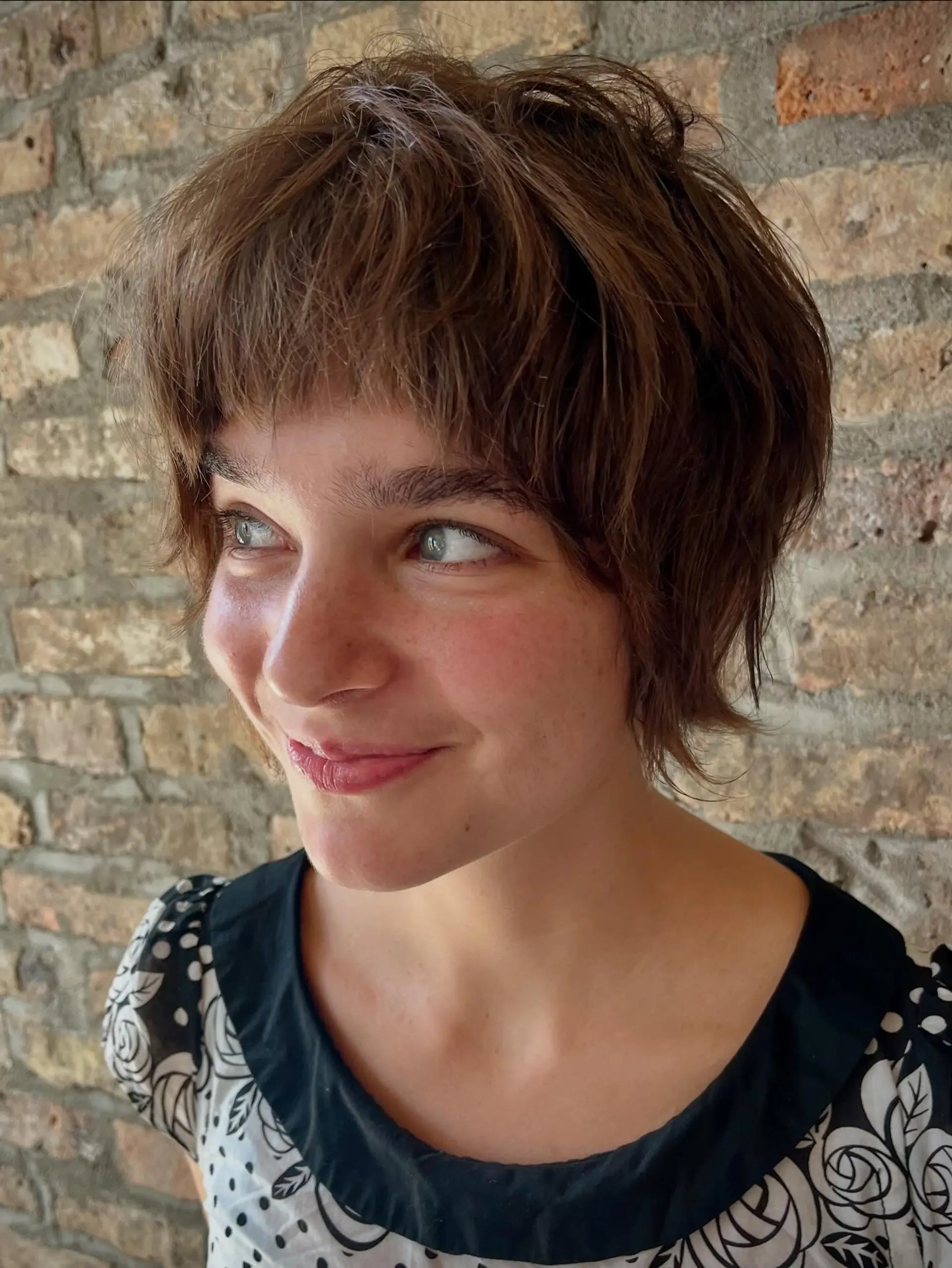 A shaggy pixie bob with choppy layers and full bangs. 2