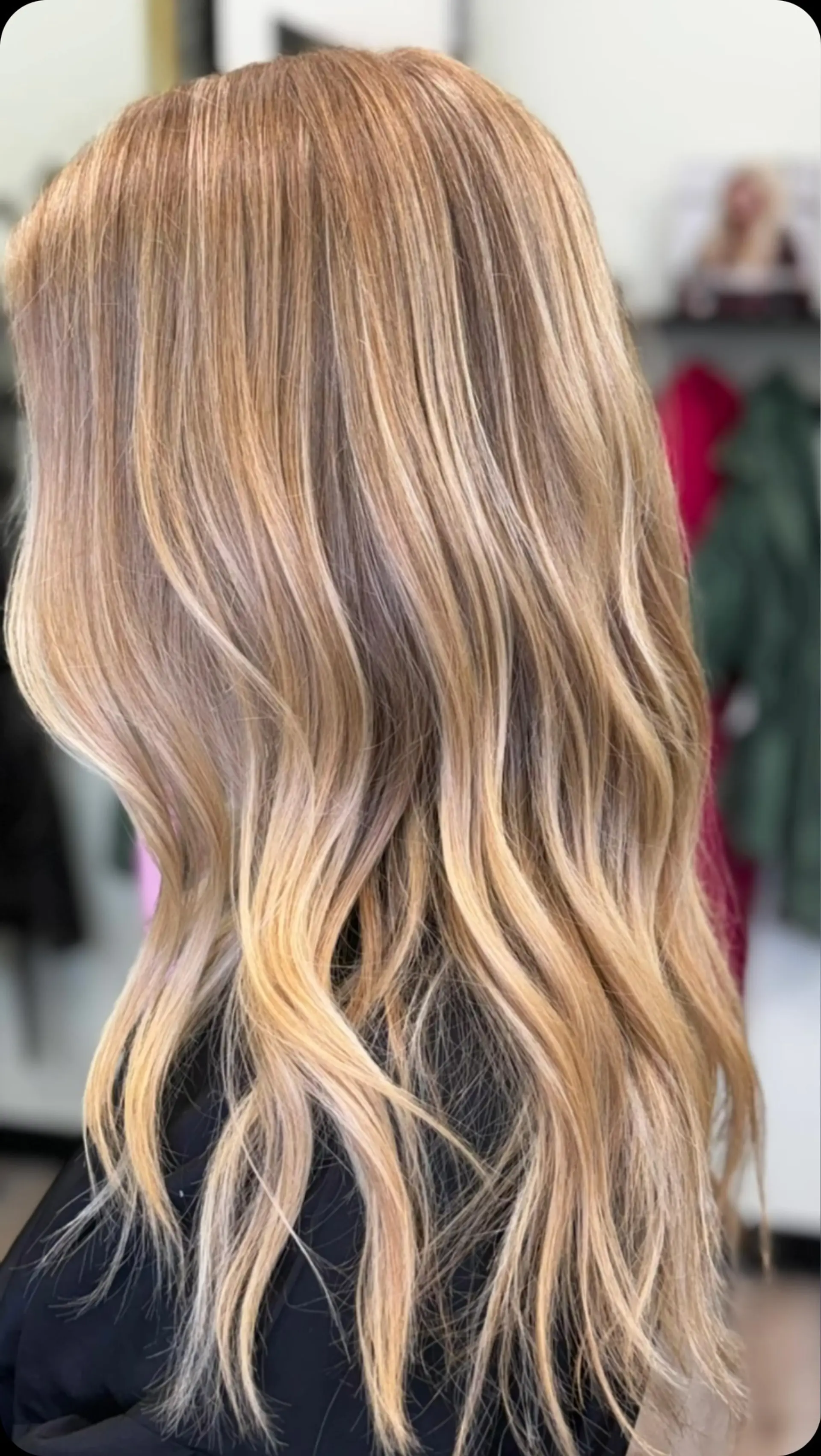 Long dimensional honey blonde hair styled with soft, loose waves. 1