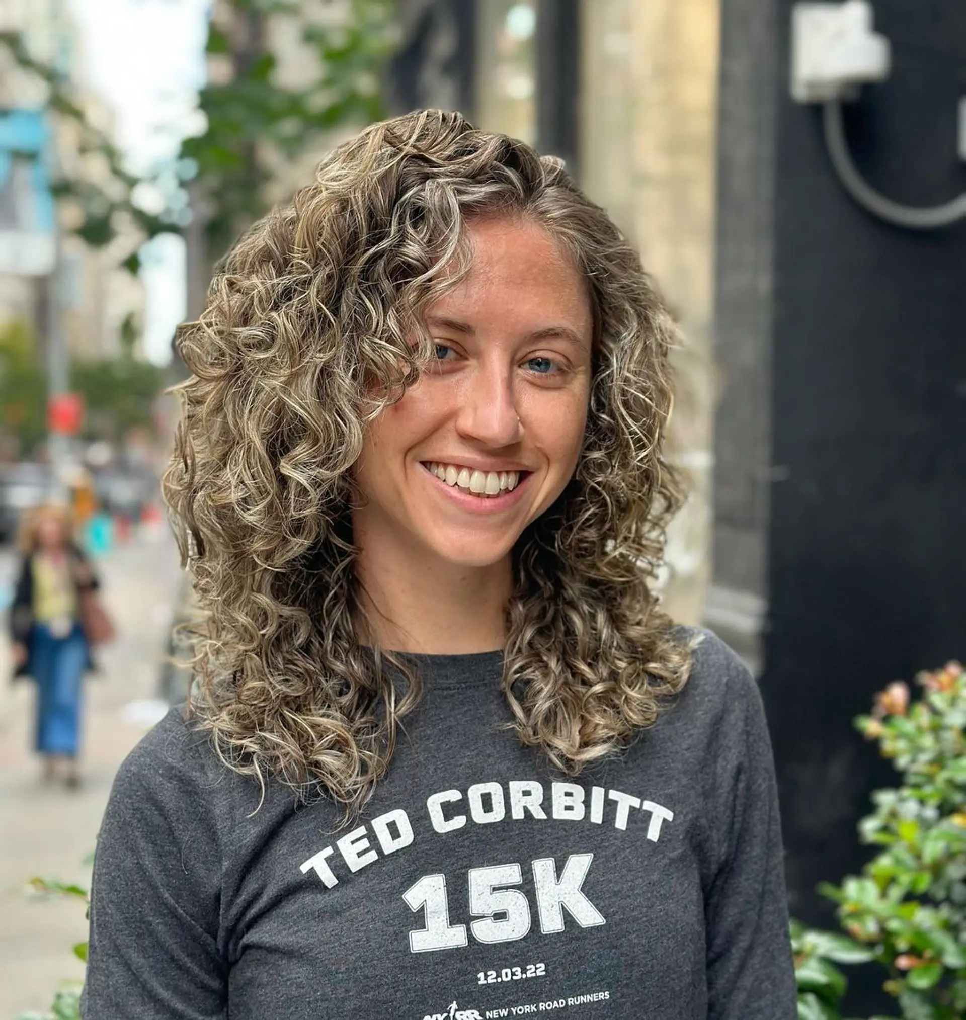 Medium-length, natural bouncy curls with blonde highlights over a light brown base, layered for volume and depth.

Color by @simabeautynyc
Cut and style by @juliamannino_hair
 1