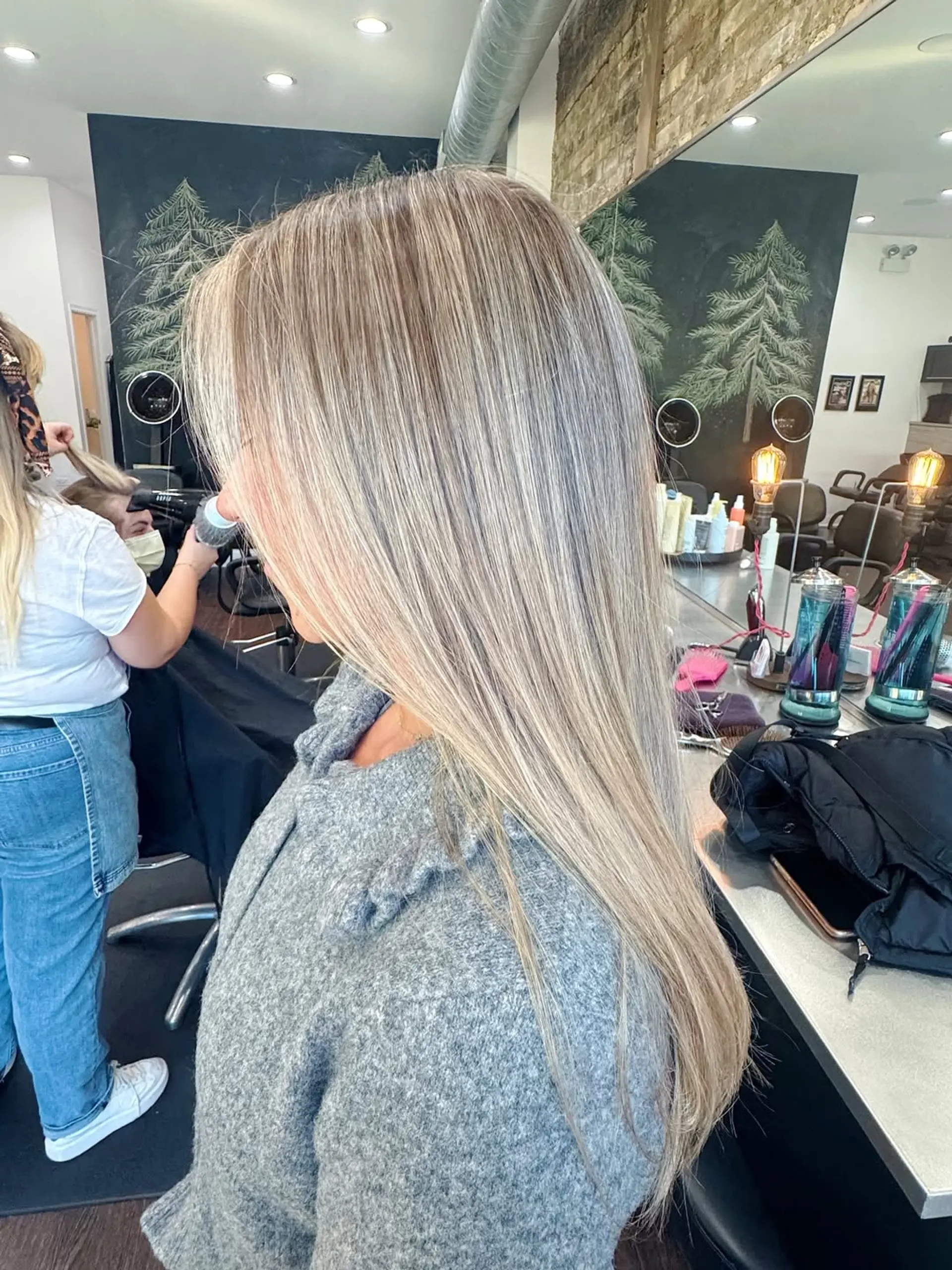 Long, straight hair styled with a full dimensional ash blonde balayage, incorporating bright platinum highlights for a radiant and modern finish. 1