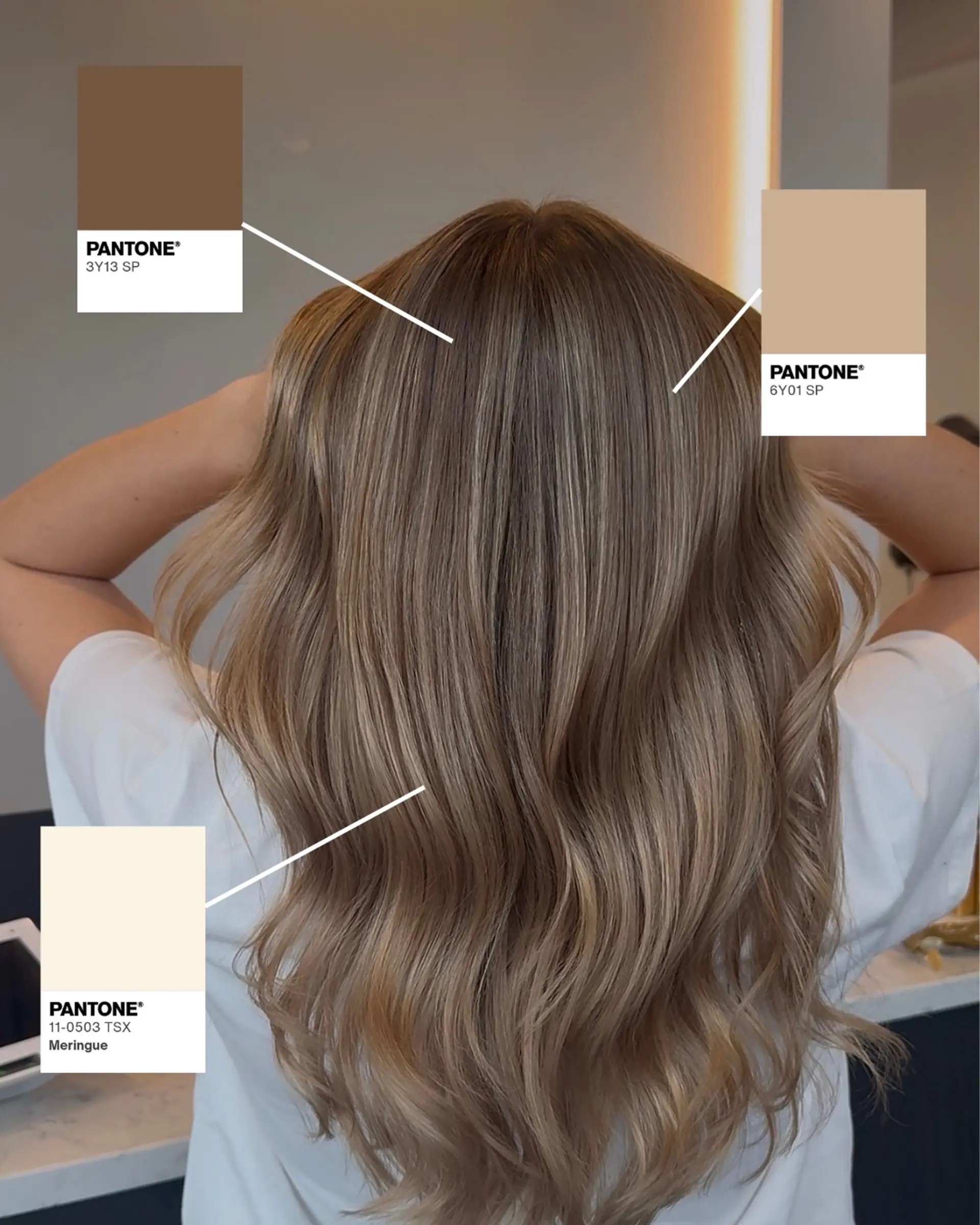 Long hair featuring a seamless dimensional beige blonde balayage styled with soft, loose waves. 1