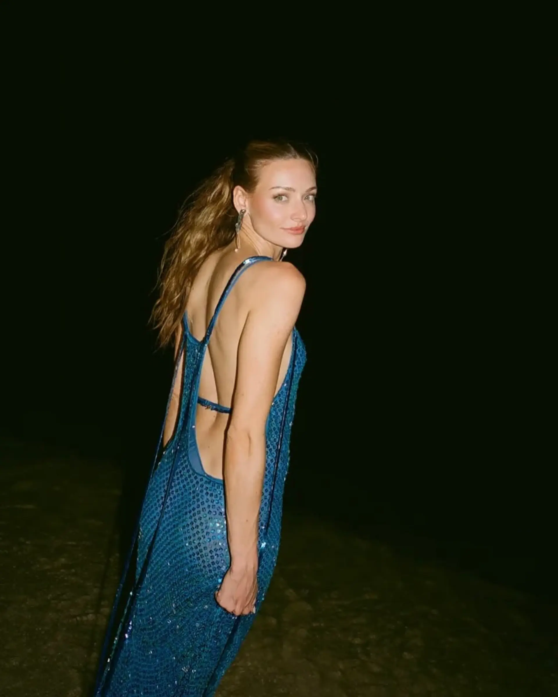 A sleek, brushed-back high ponytail with natural, textured waves cascading down the back. 1