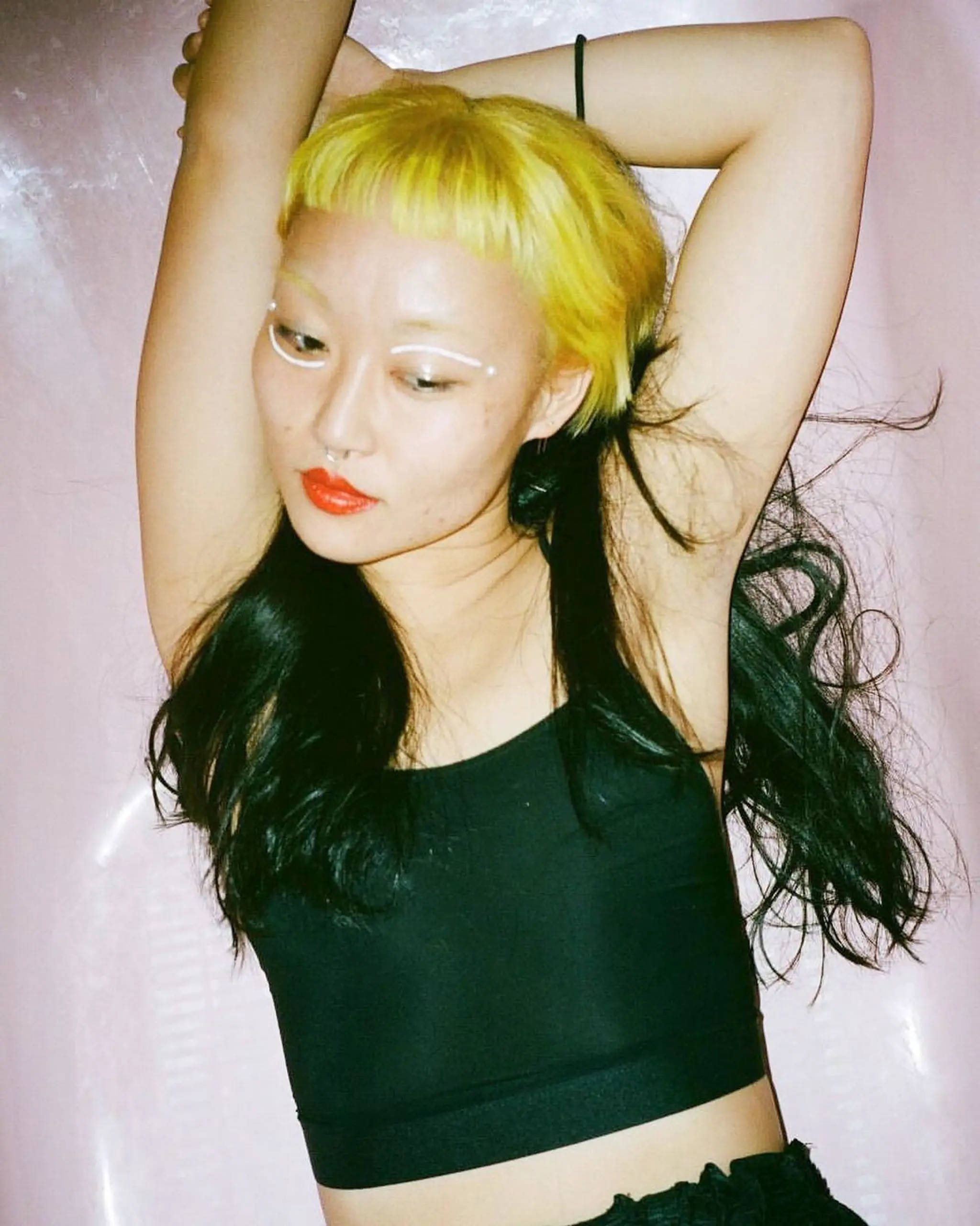 Edgy hairstyle with bright yellow blunt bangs and long black wavy locks, creating a bold contrast and a punk flair. by @takeohair  1