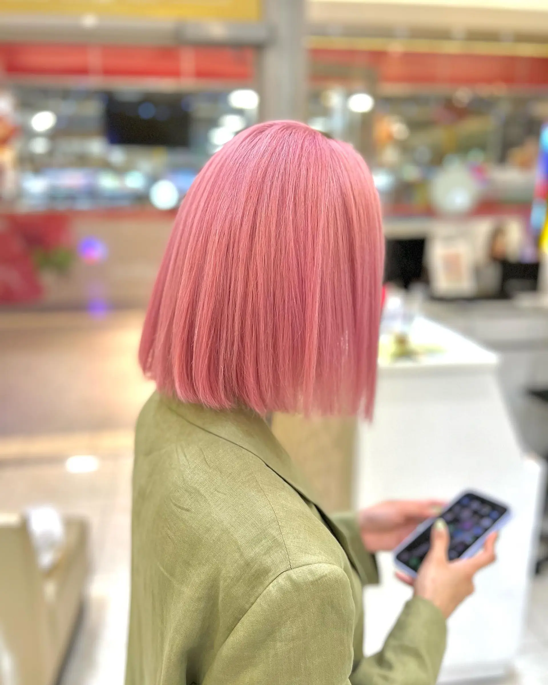 A straight, blunt bob cut with a vibrant, pink color. 1
