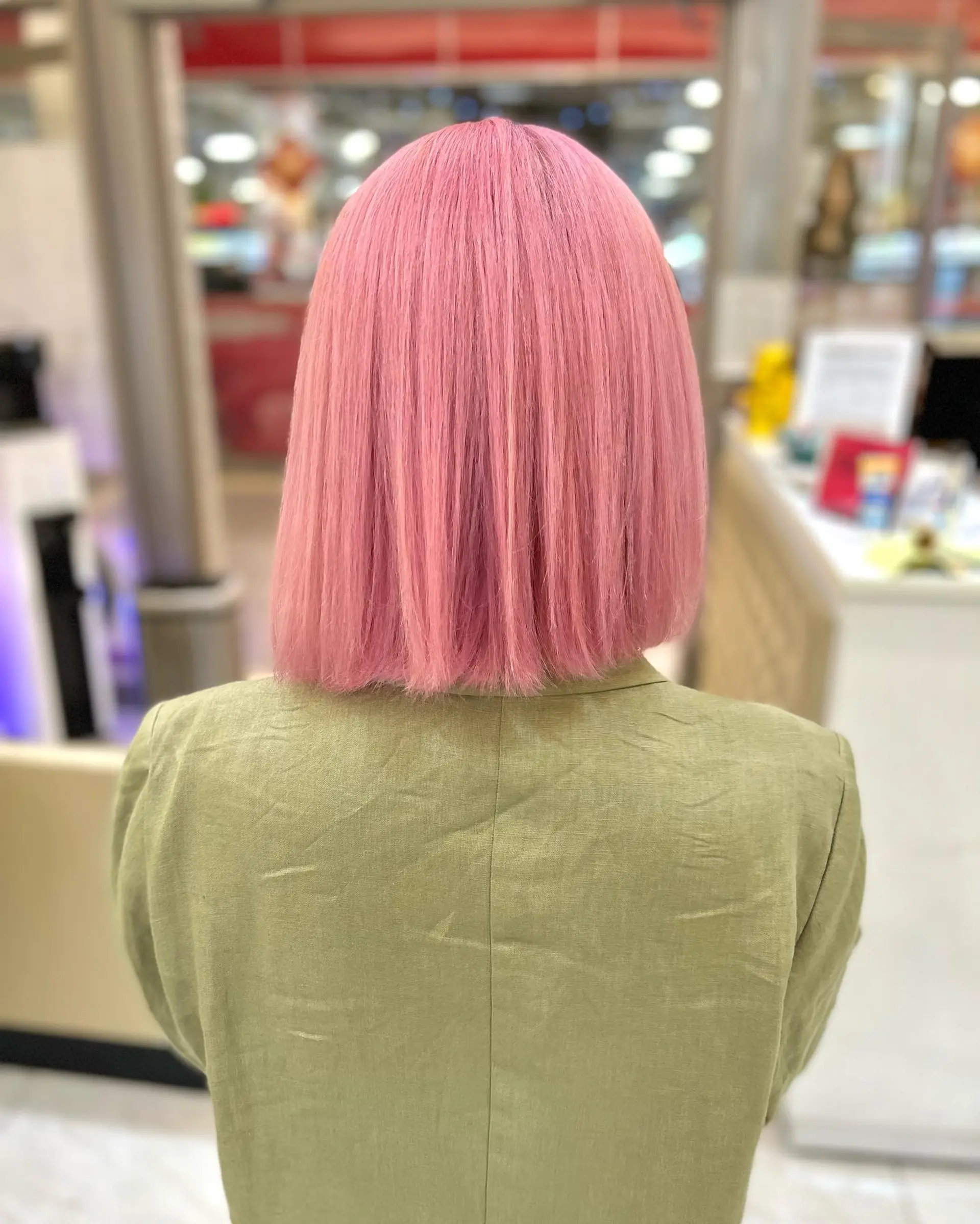 A straight, blunt bob cut with a vibrant, pink color. 2