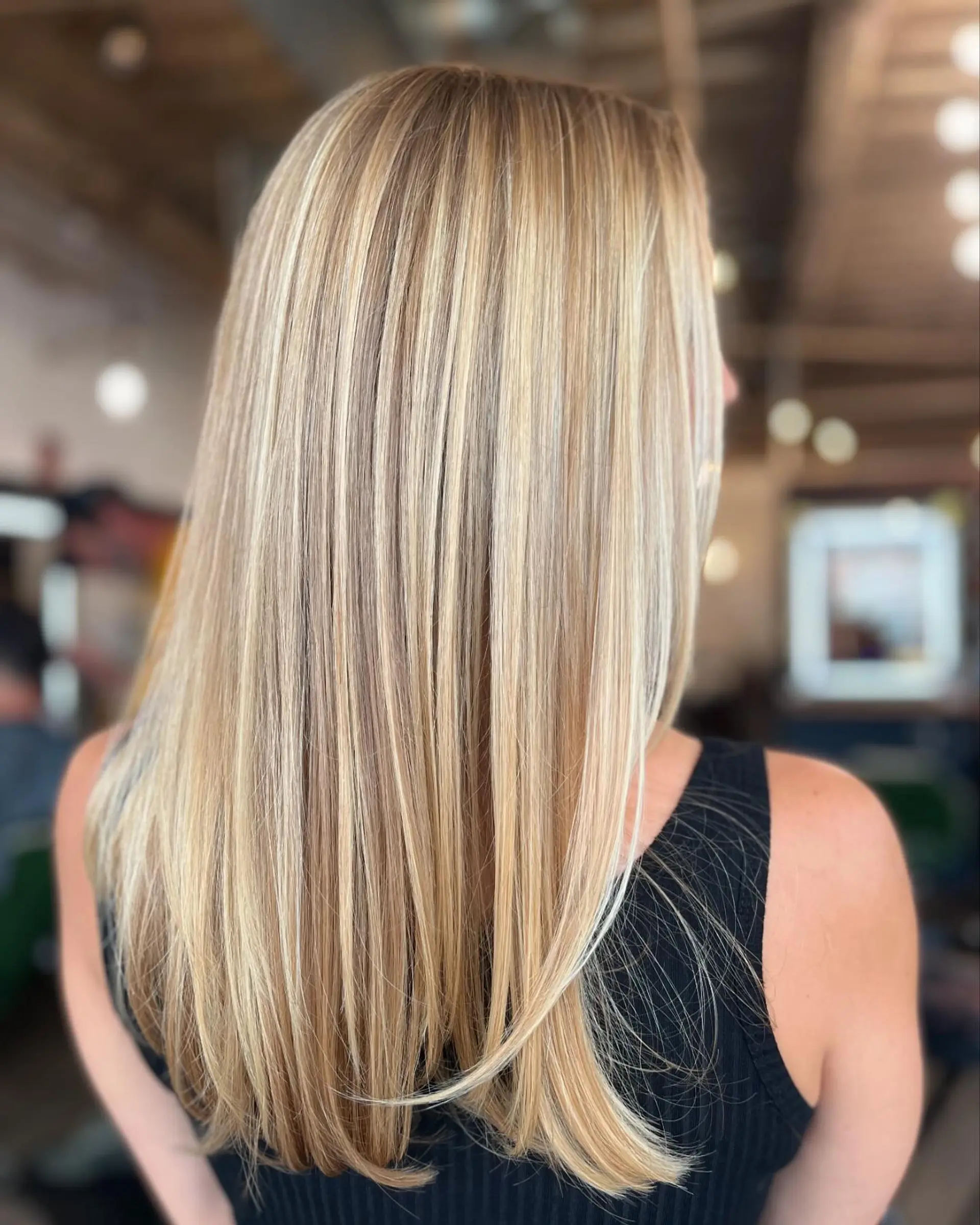 Long straight blonde hair with multidimensional highlighted strands and smoothly finished ends. 1