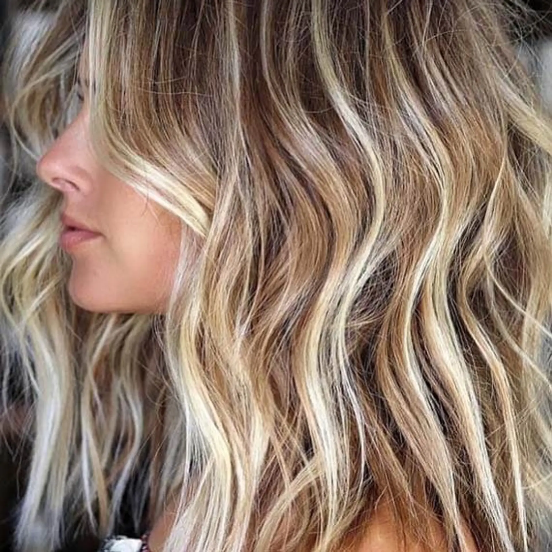 Bronde balayage with layered waves for a beachy and dimensional look. 1