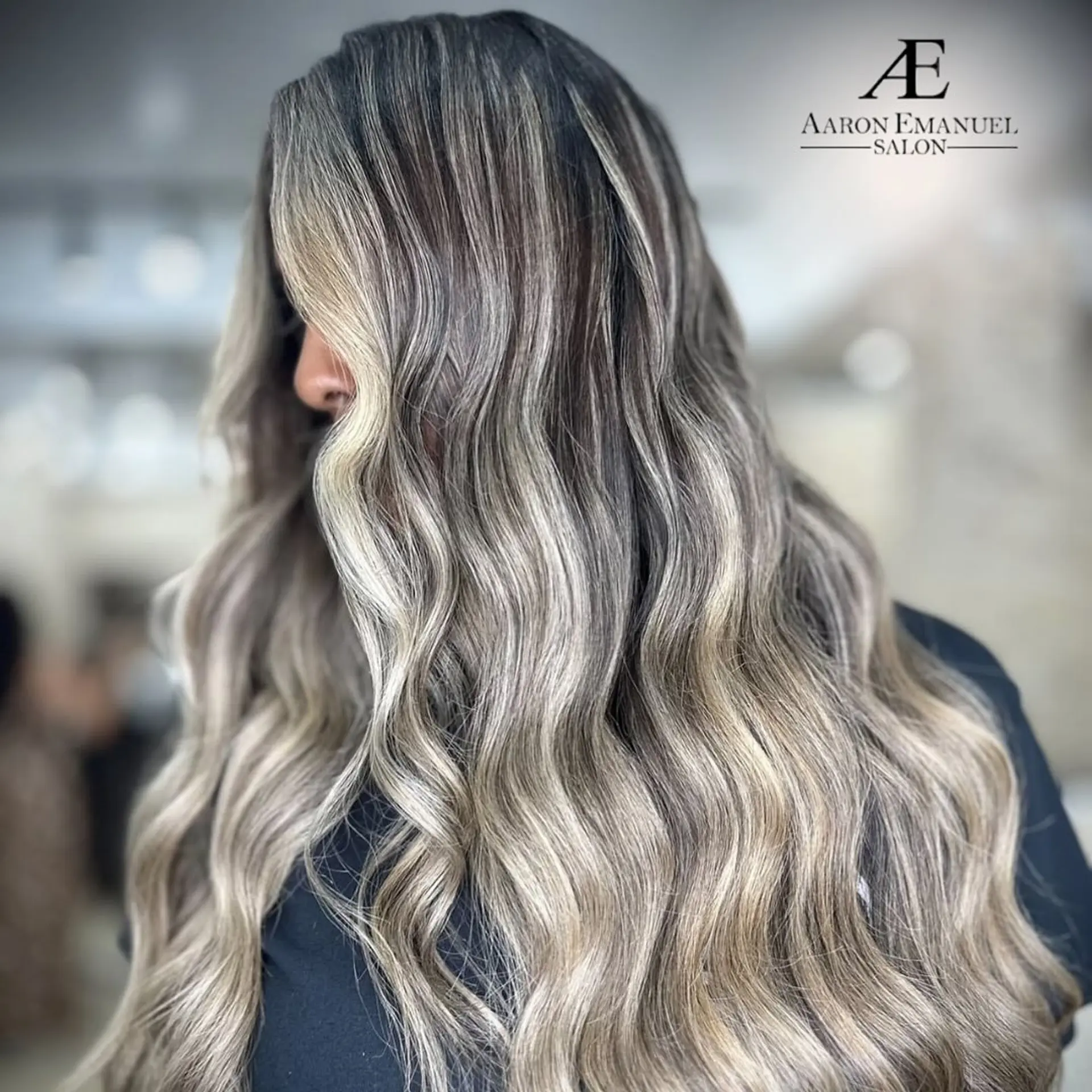 A very long, wavy hairstyle with an ash blonde balayage effect. 1