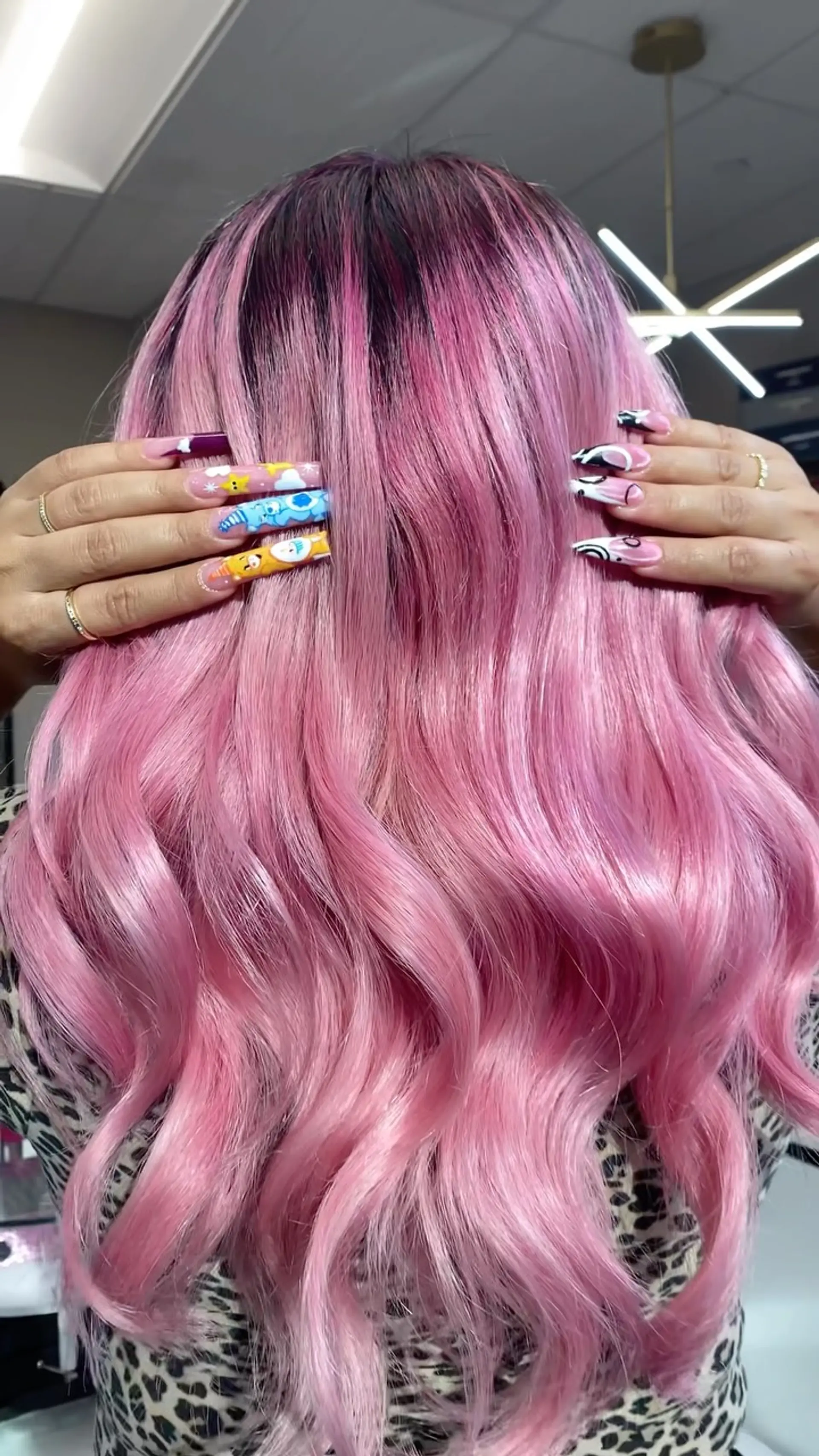 Vibrant pastel pink long hair with a natural dark shadow root, styled into glossy, loose waves. 1