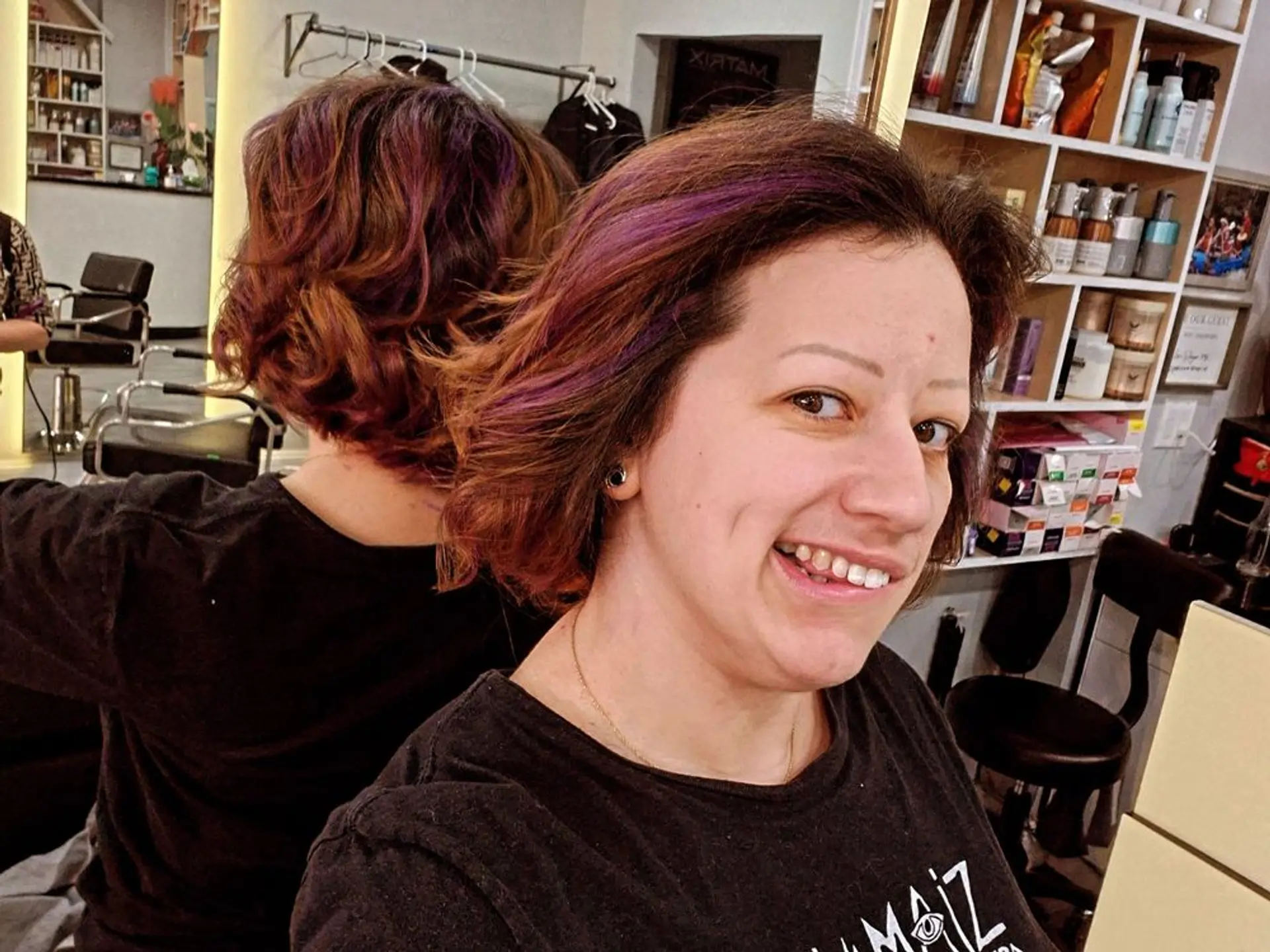 A medium wavy bob with auburn and brown tones and purple highlights. 1