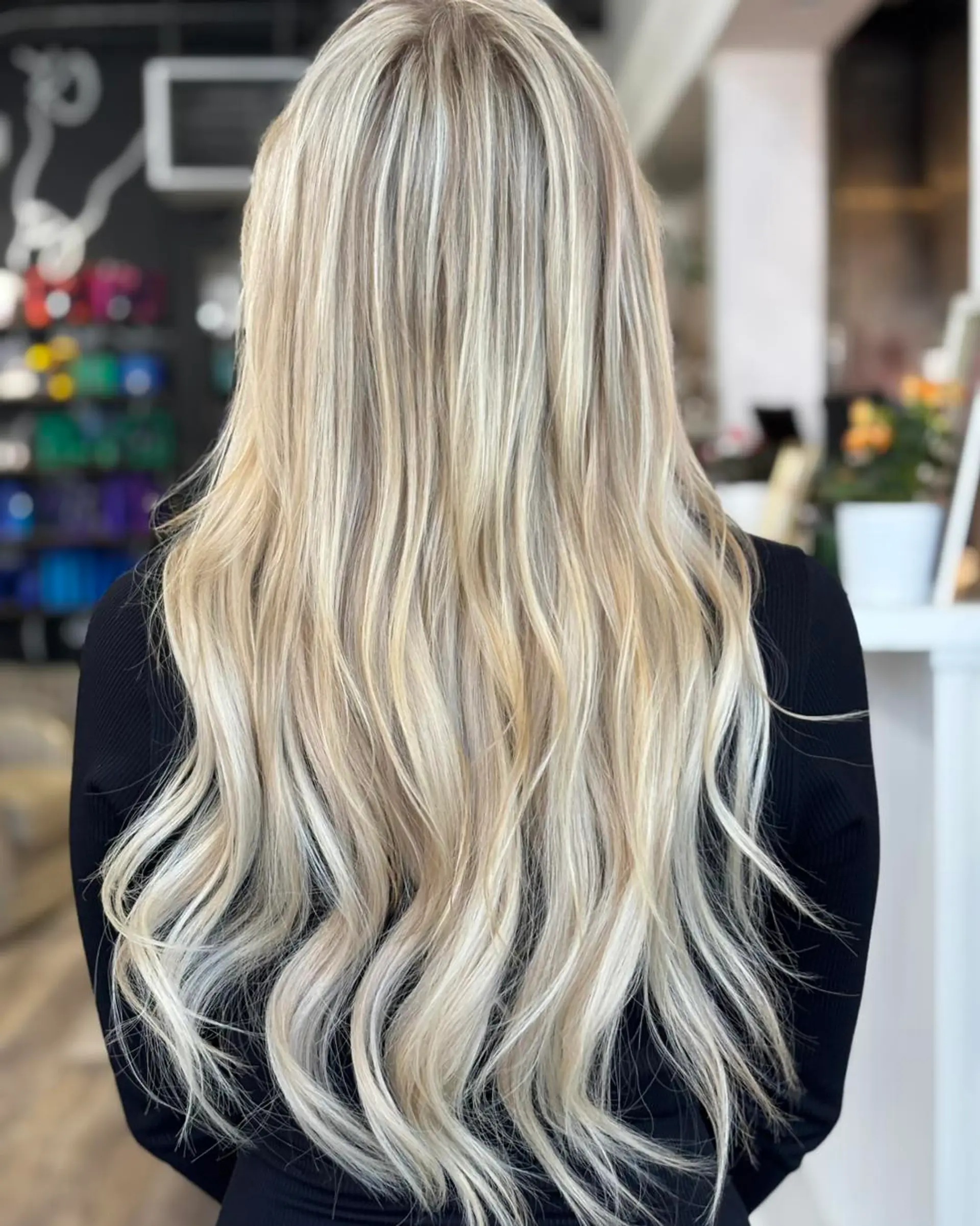 Extra-long dimensional blonde hair styled with soft, cascading waves. 1