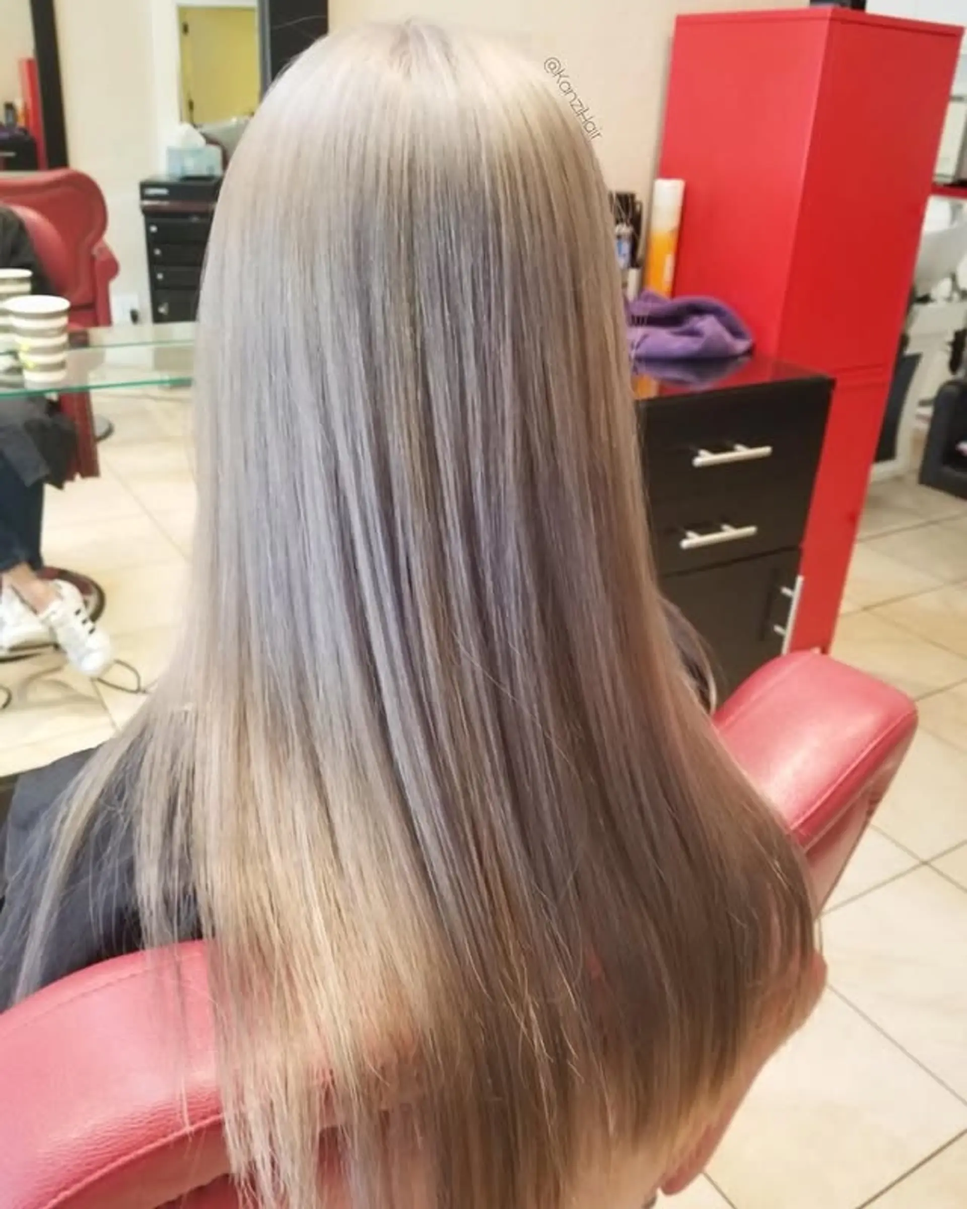 A sleek, long hairstyle with straight, smooth strands, featuring a gorgeous ash silver blonde color with cool undertones. 1