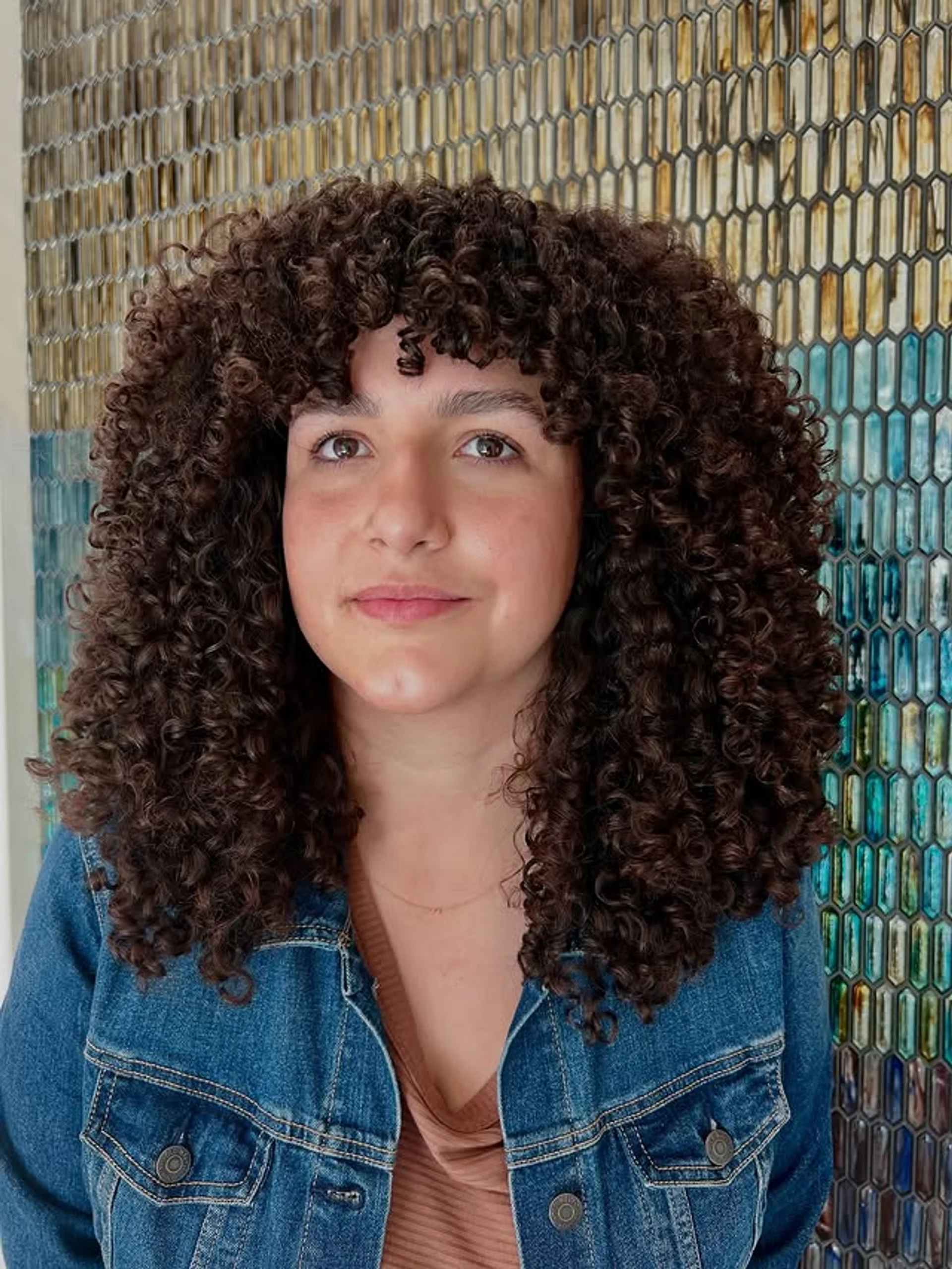 A person with a curly shag haircut and full, textured curly bangs. - Preview 2