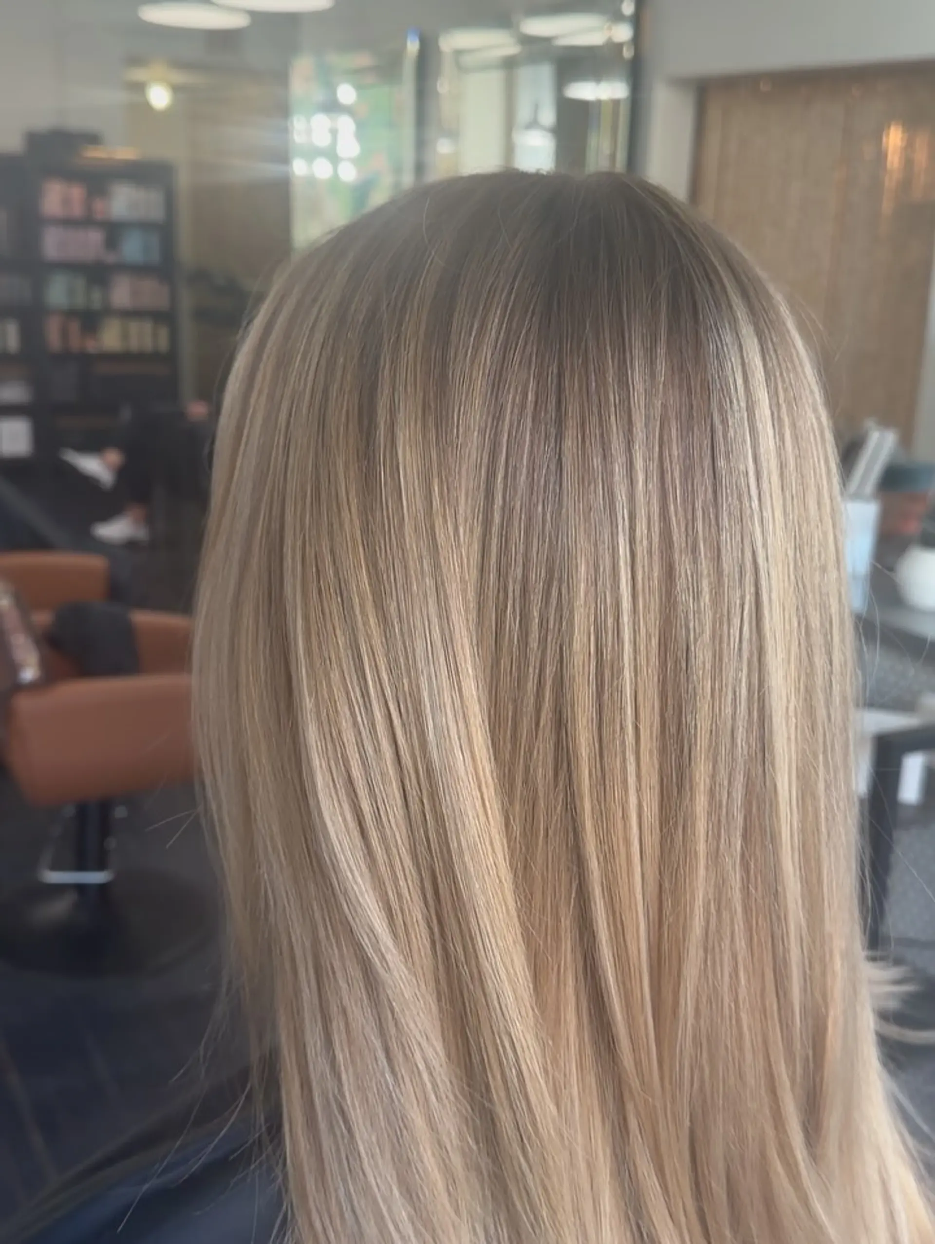 Smooth, straight long hair with multi-tonal dimensional blonde highlights and soft lowlights. 1
