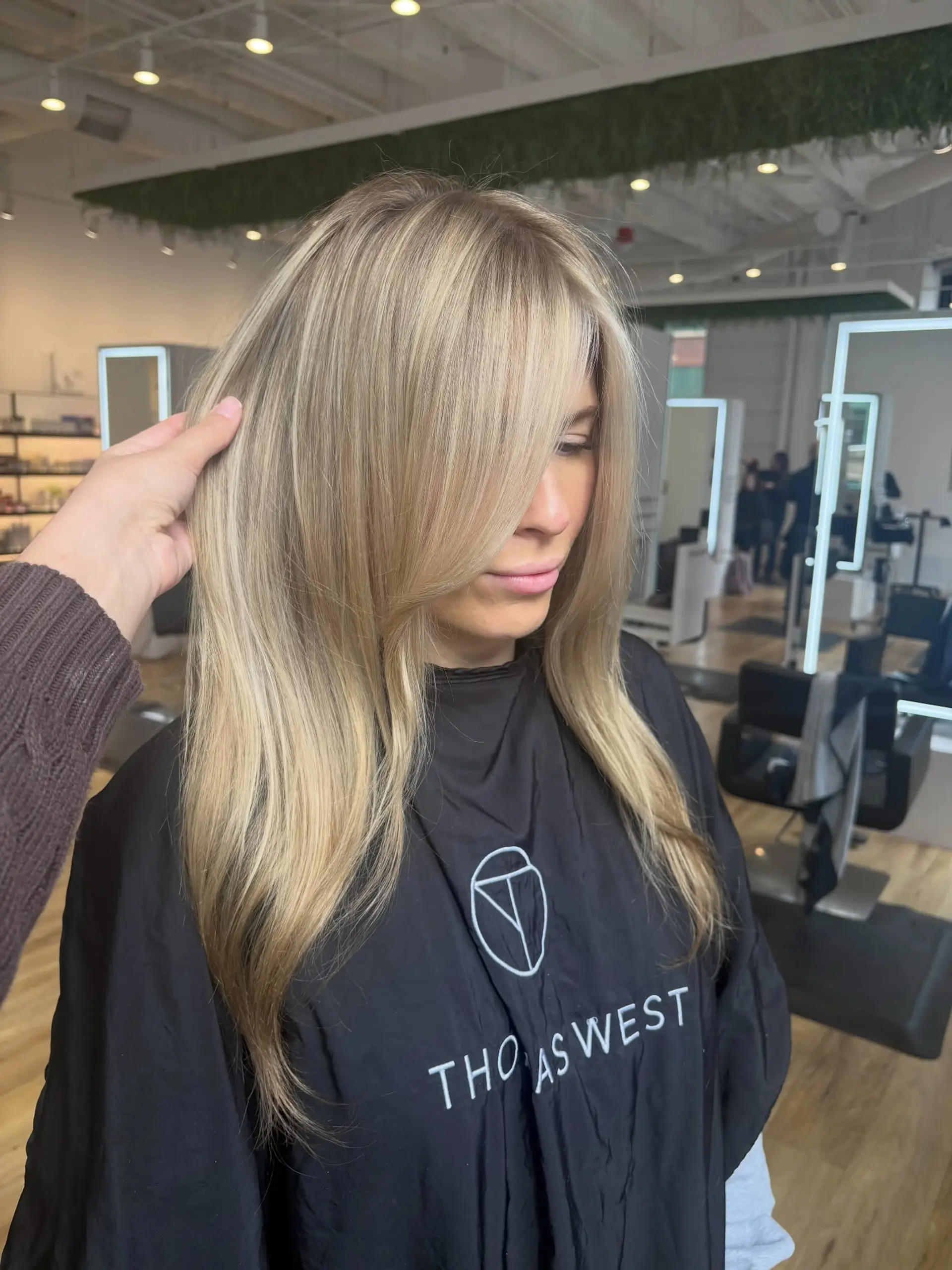 Long creamy blonde hair styled with soft face-framing layers and a smooth finish. 1