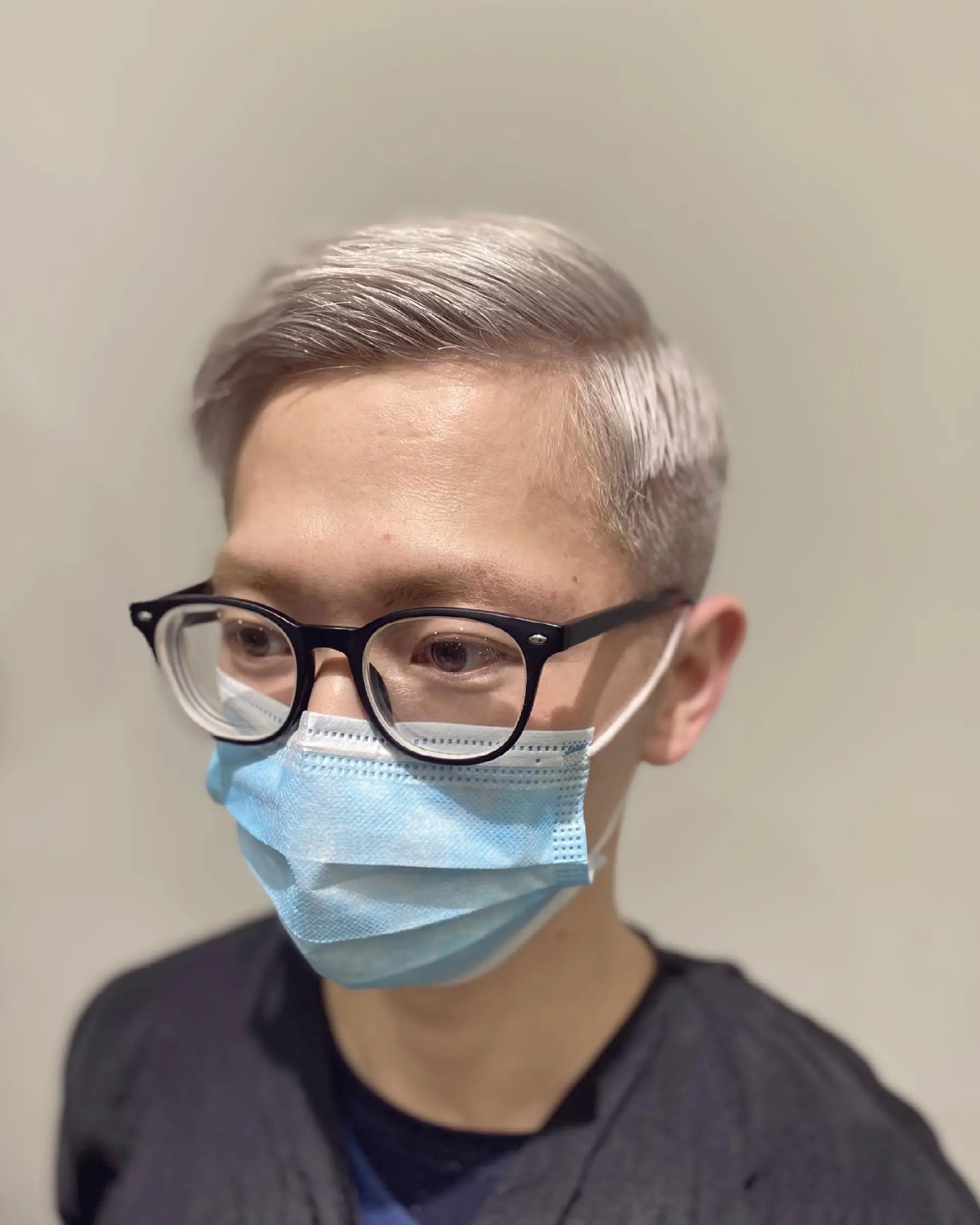 A short, textured buzz cut, bleached to a striking platinum blonde/silver. 3