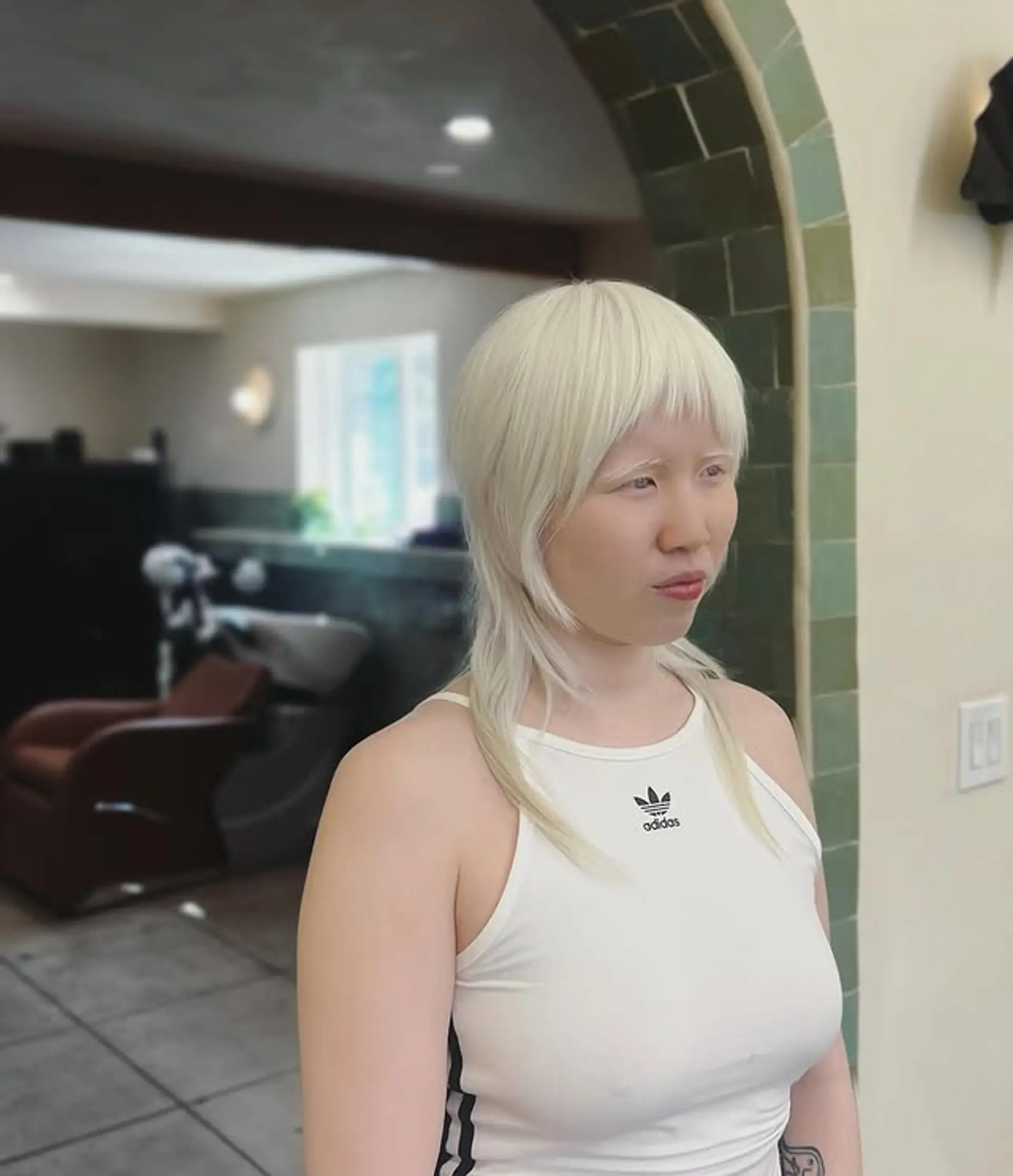 This modern shag mullet features a choppy, textured cut with short bangs and a longer length in the back. 1