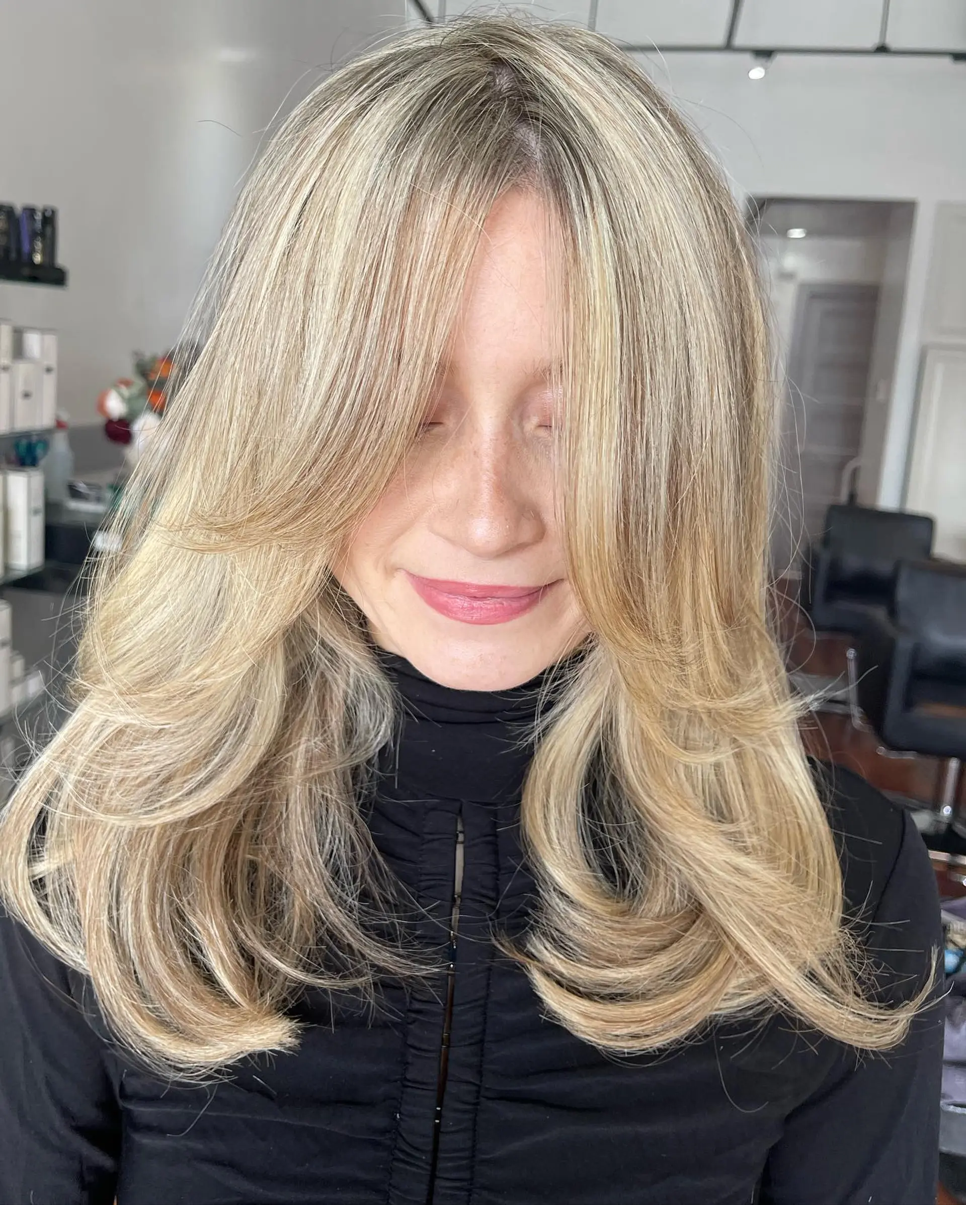 Long butterfly haircut featuring heavy face-framing layers and soft, curled-under ends. 1