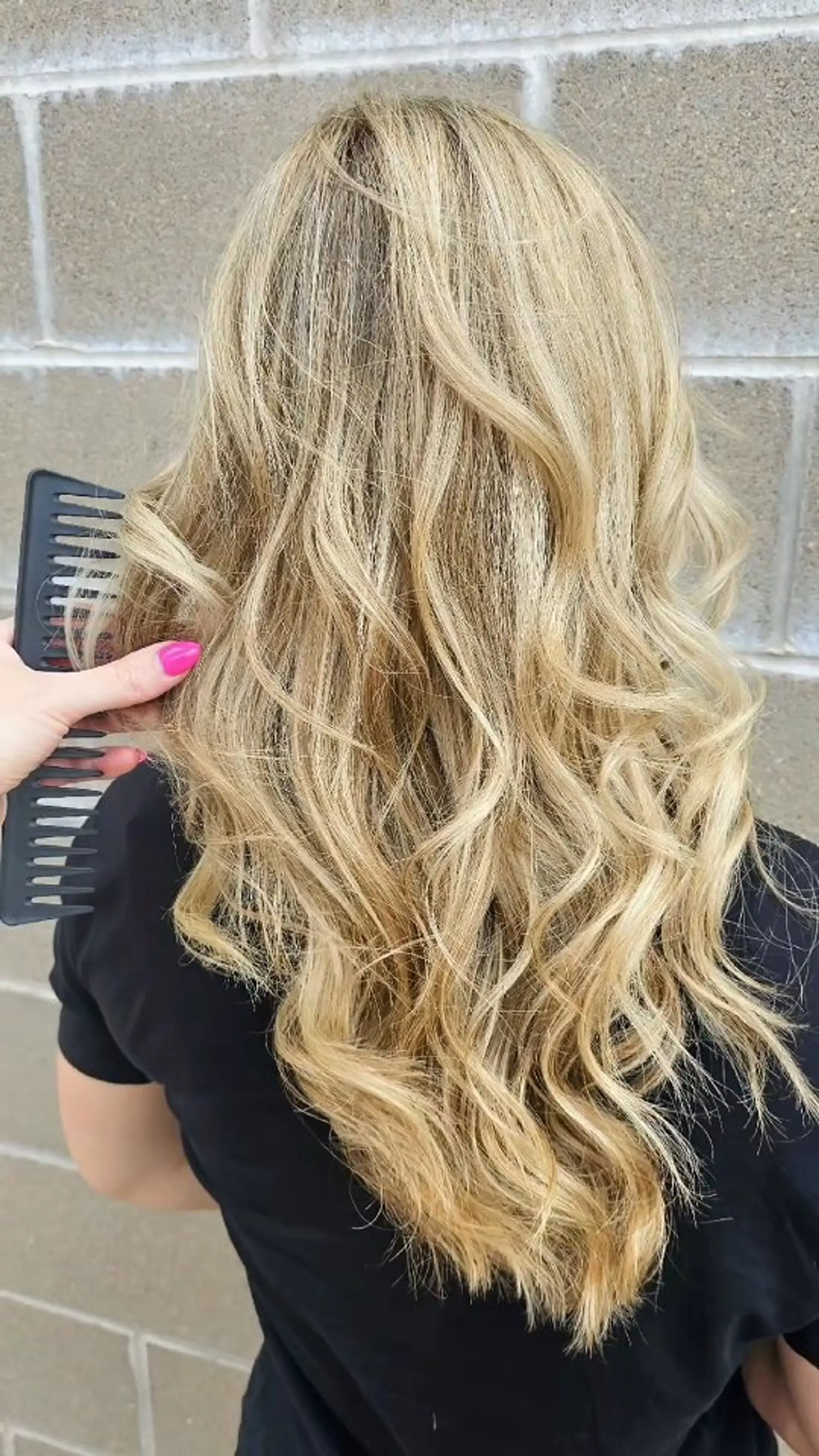 Long dimensional blonde hair styled in soft, cascading waves. 1
