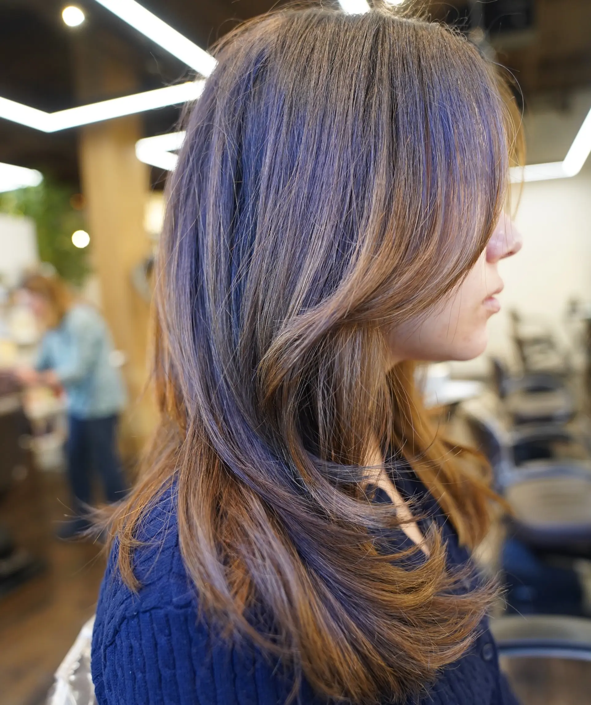 Medium-length straight hair with long layers and face-framing layers, dimensional brunette coloring, auburn highlights and a shadow root. 1