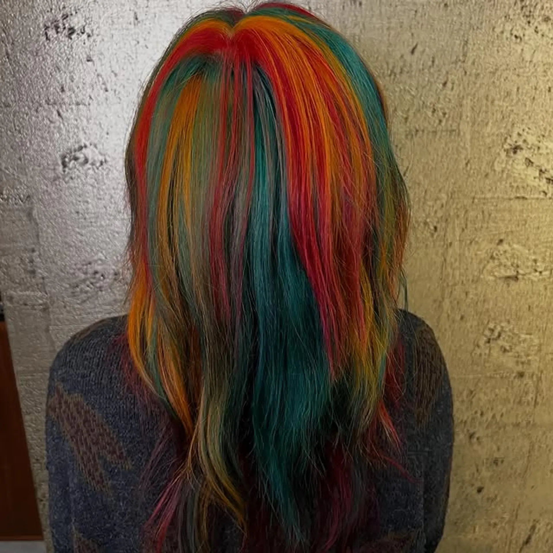 A vibrant rainbow-colored, straight hairstyle with a medium length. 1