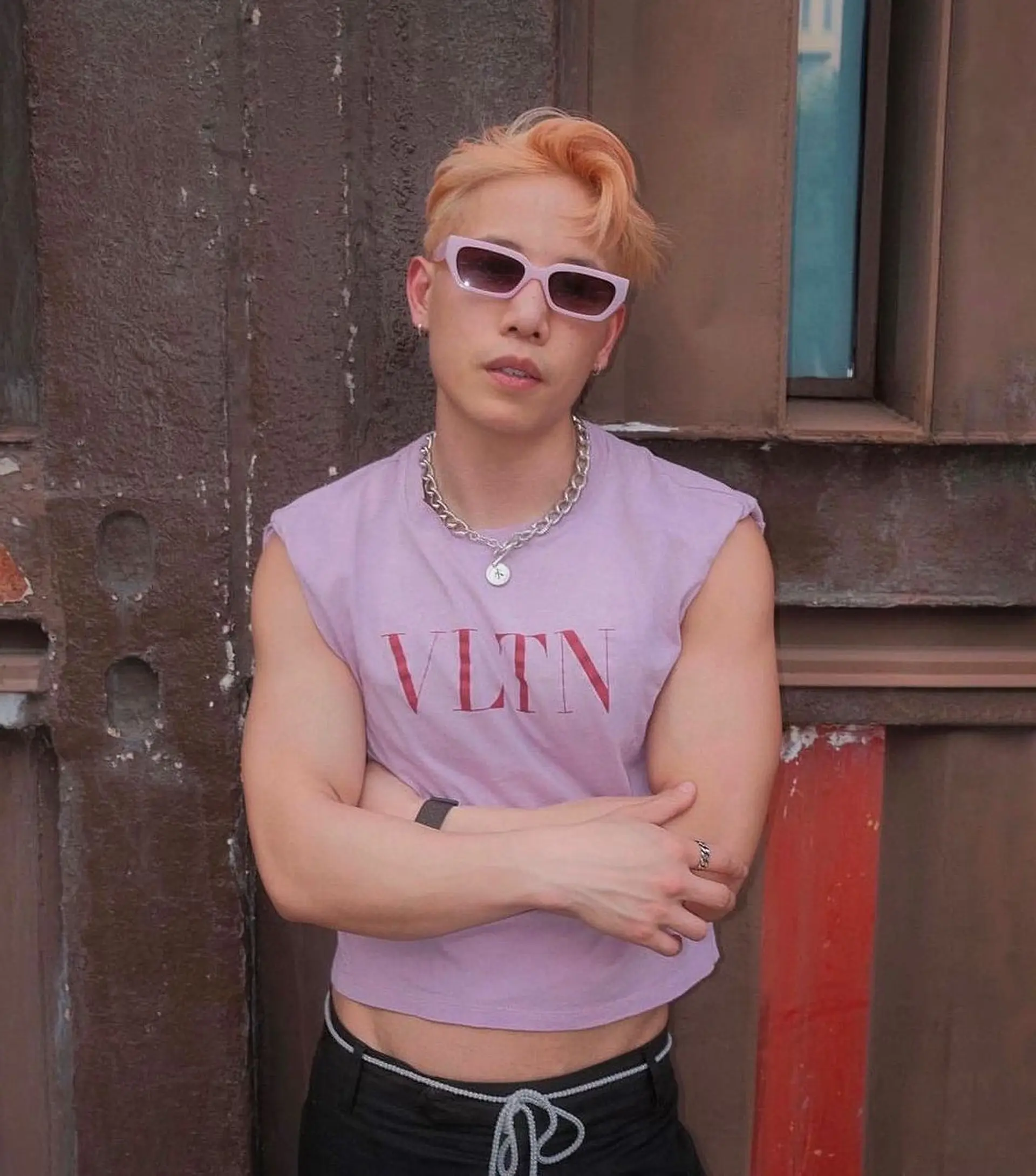 This striking hairstyle features a fashionable quiff styled in a messy, casual manner. The hair is short and exhibits a wavy texture with vibrant shades of peach, blonde, and hints of pink. The layered and textured cuts give it a modern, edgy look. 1