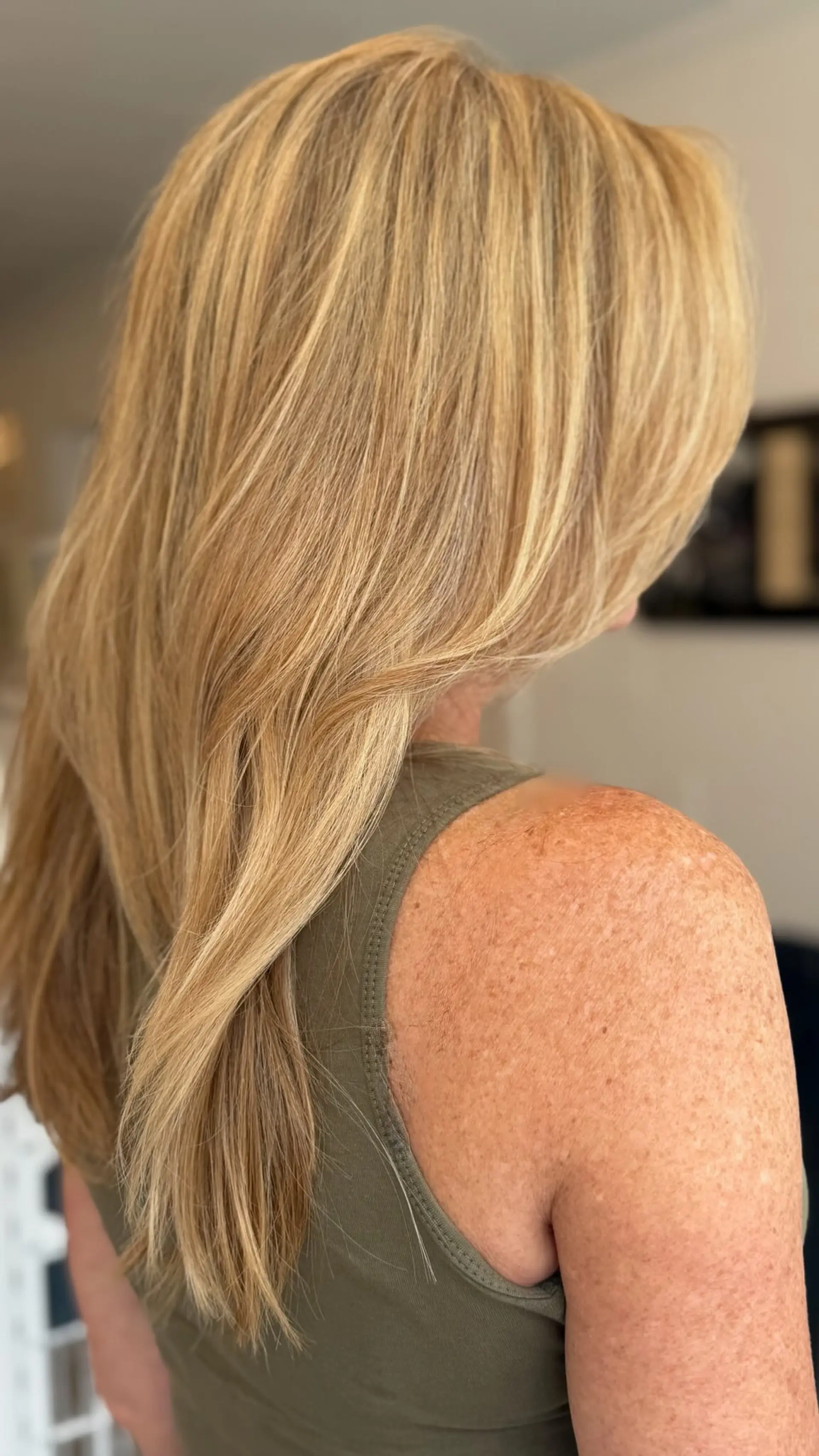Long smooth golden blonde hair with warm dimensional highlights and long face-framing layers. 1