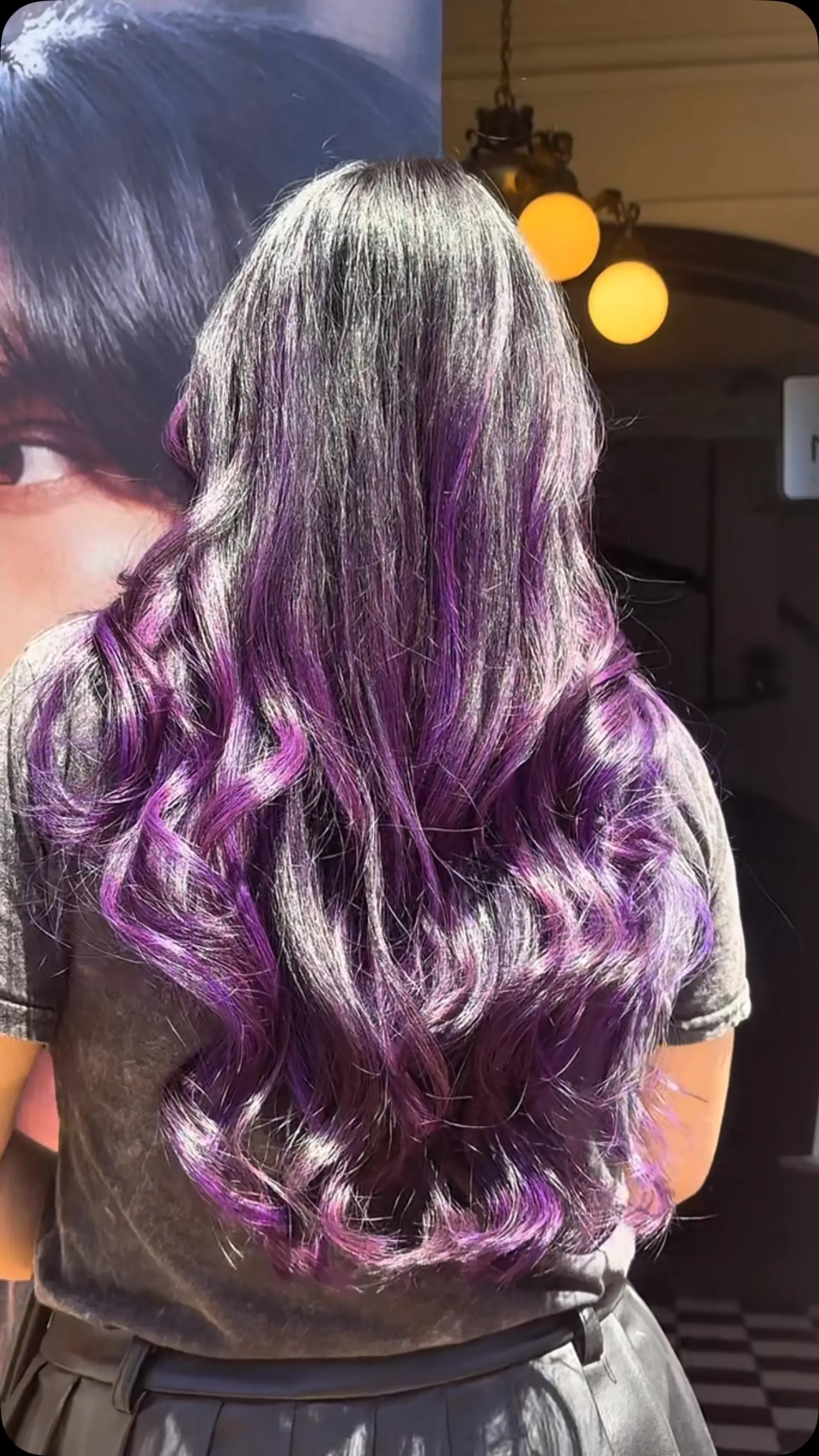 Long, dark hair styled in flowing, loose waves with bright purple and violet balayage highlights. 1