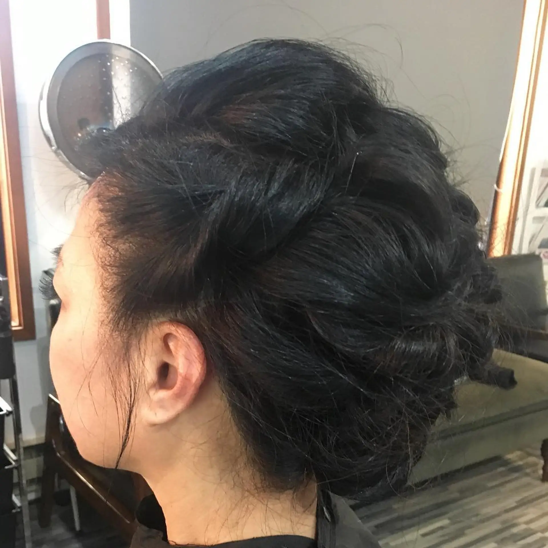 A voluminous formal updo featuring twisted sections pinned into an elegant, textured silhouette. 1