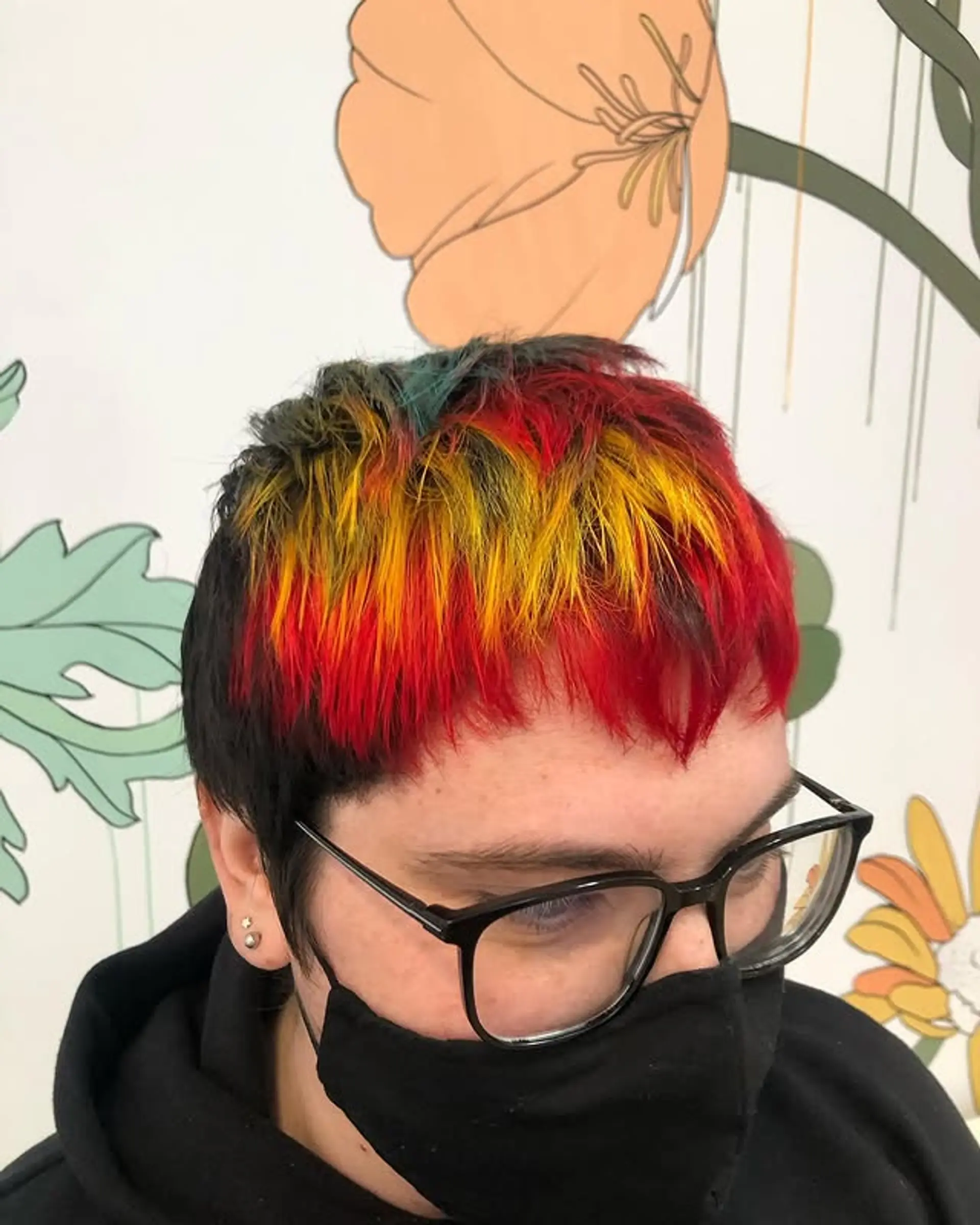 A textured pixie cut with sections of red, yellow, and green. 1