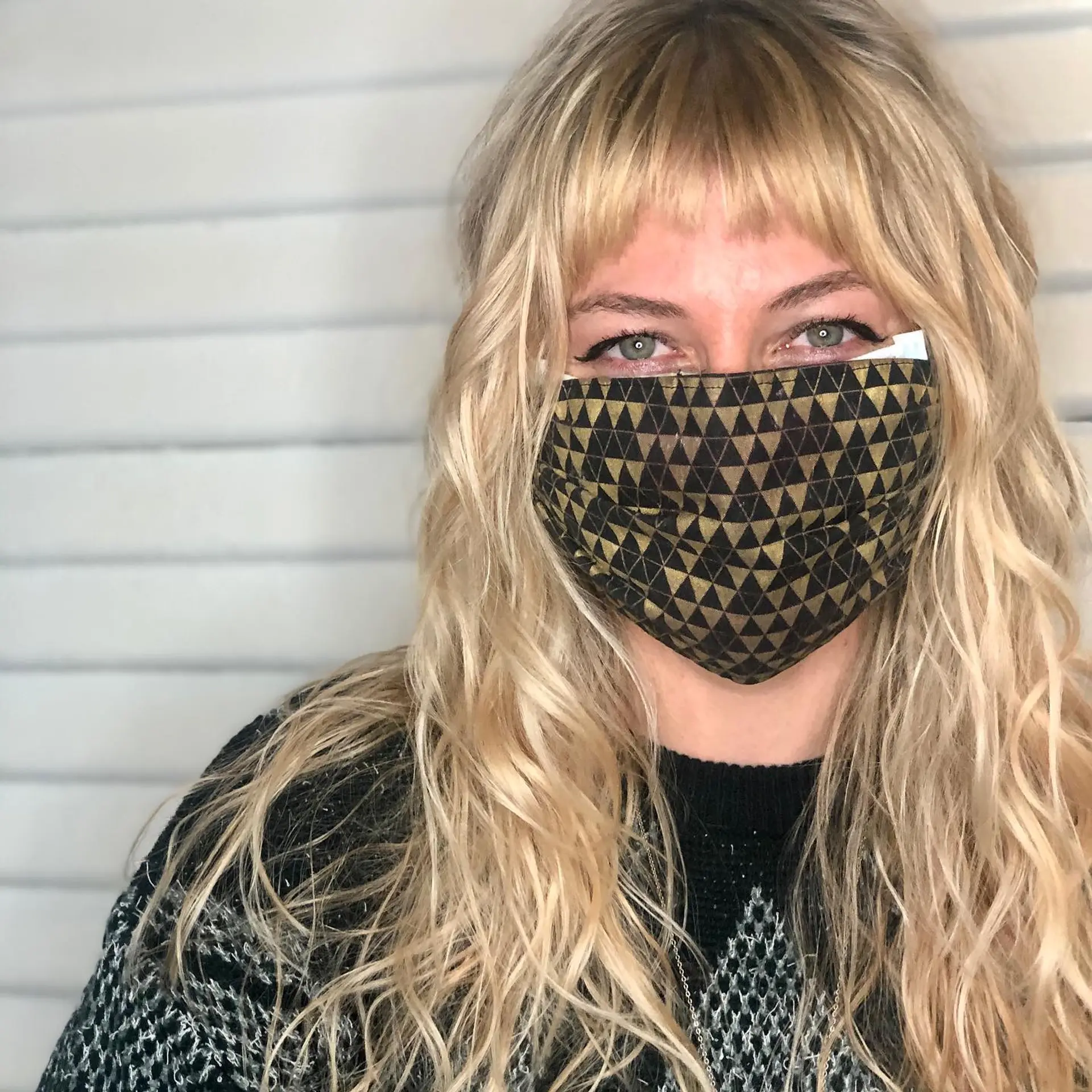 A textured blonde shag featuring piecey micro bangs and loose, tousled waves throughout the layered lengths. 1