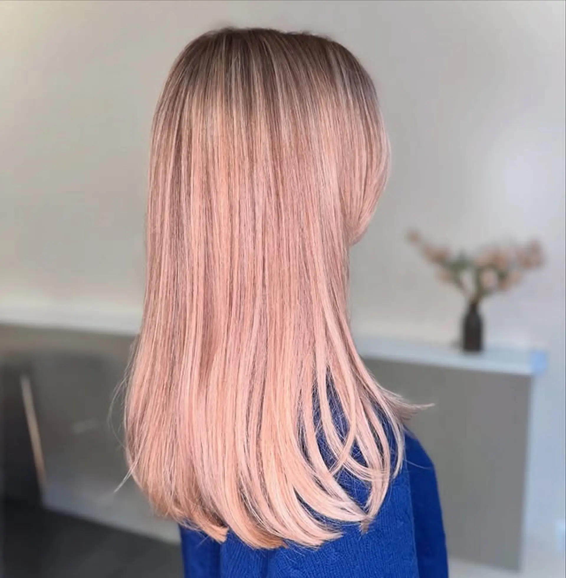 Long, straight hair with a rose gold ombre effect. 1
