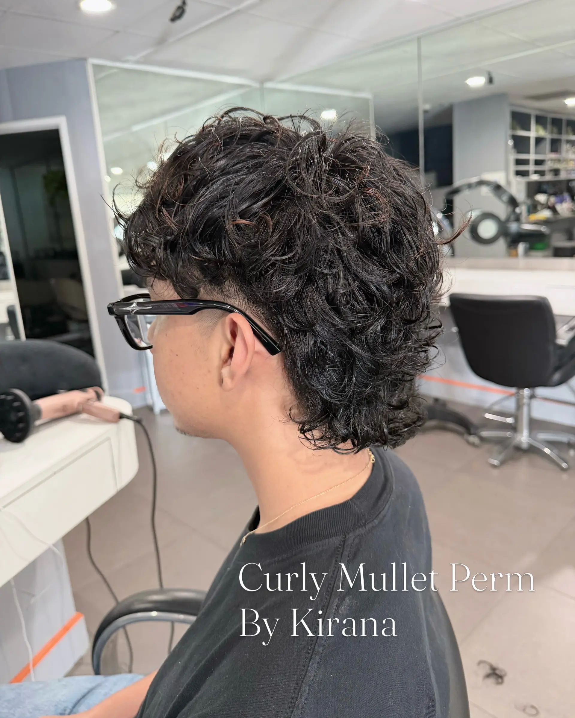 A modern curly mullet with defined, textured curls on top and at the back, paired with clean, shorter tapered sides. 1