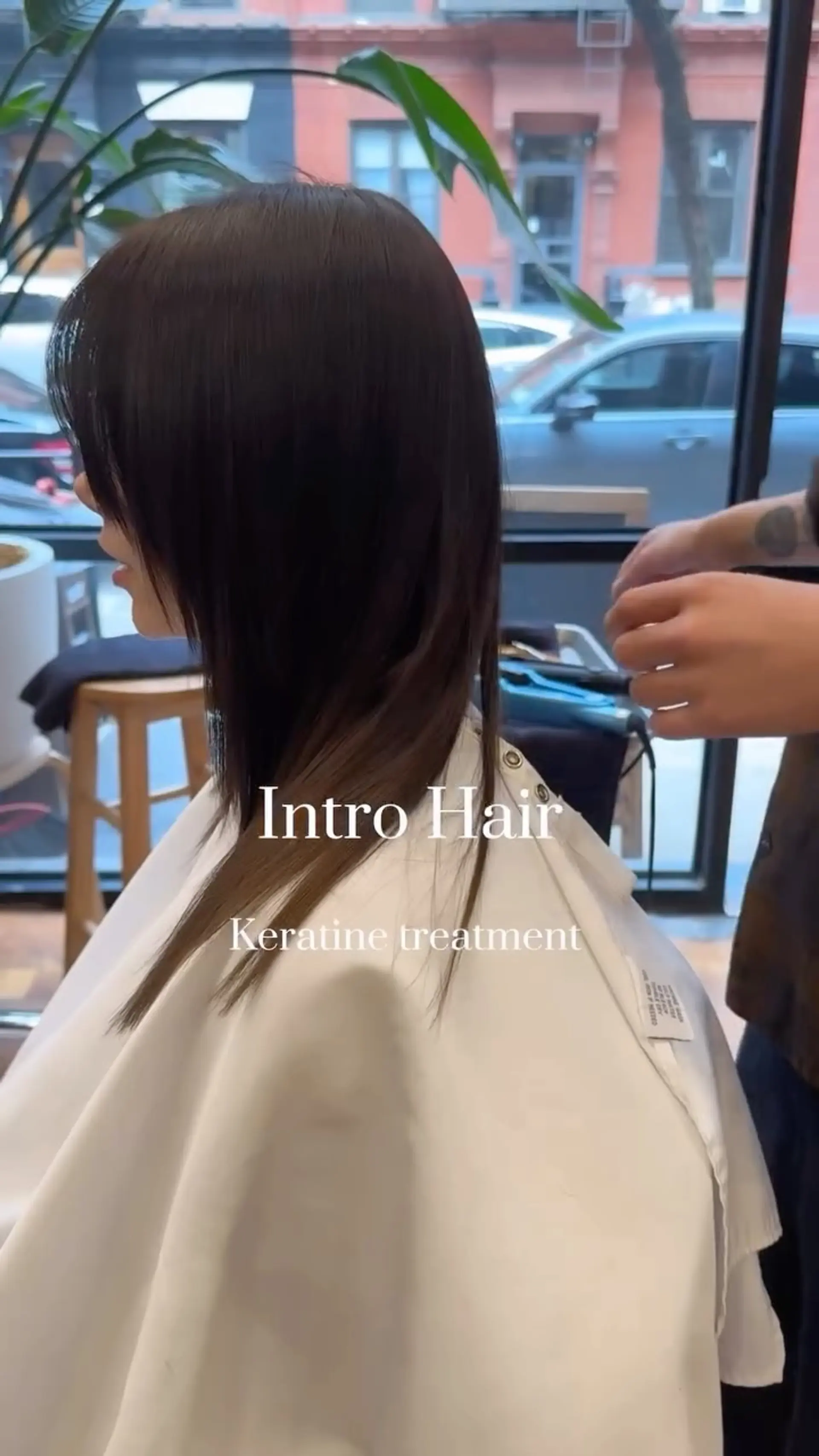 A sleek, straight medium-length haircut treated for high shine and smooth texture, completed with soft face-framing layers and side-swept bangs. 1