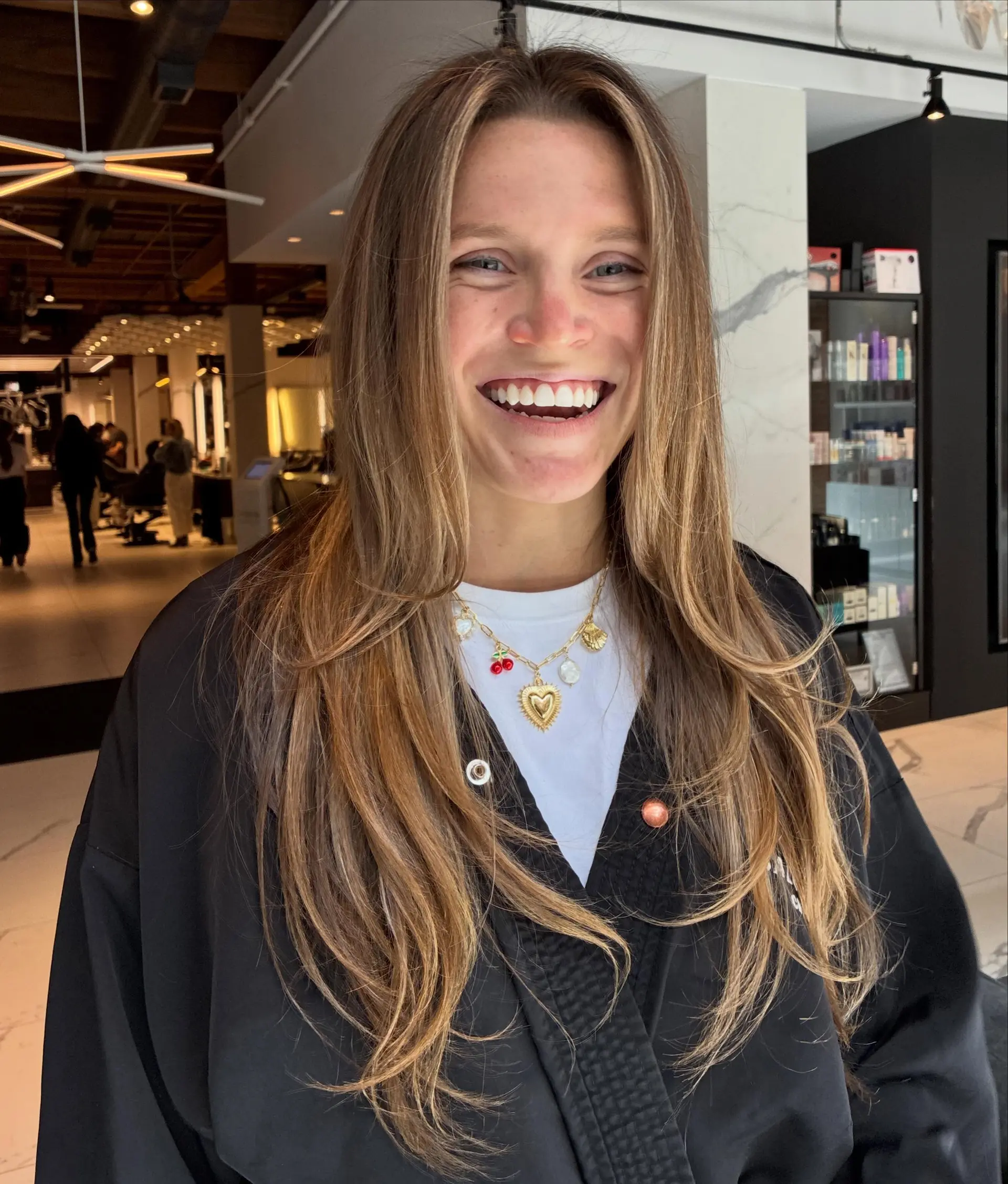Long, flowing light brown hair styled with warm honey blonde balayage highlights and soft face-framing layers. 1