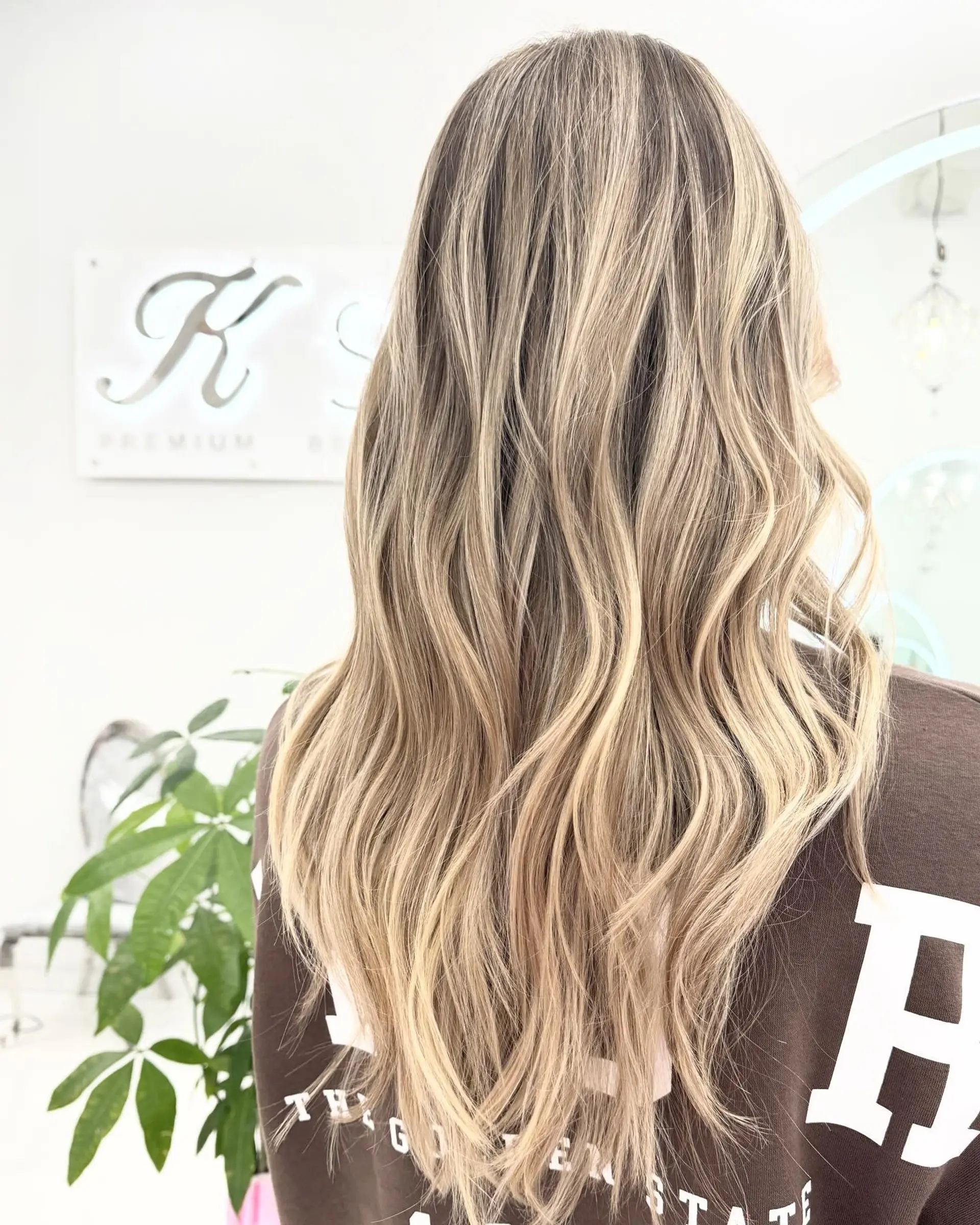 Long, wavy hairstyle with a balayage effect, creating soft beach waves. 1