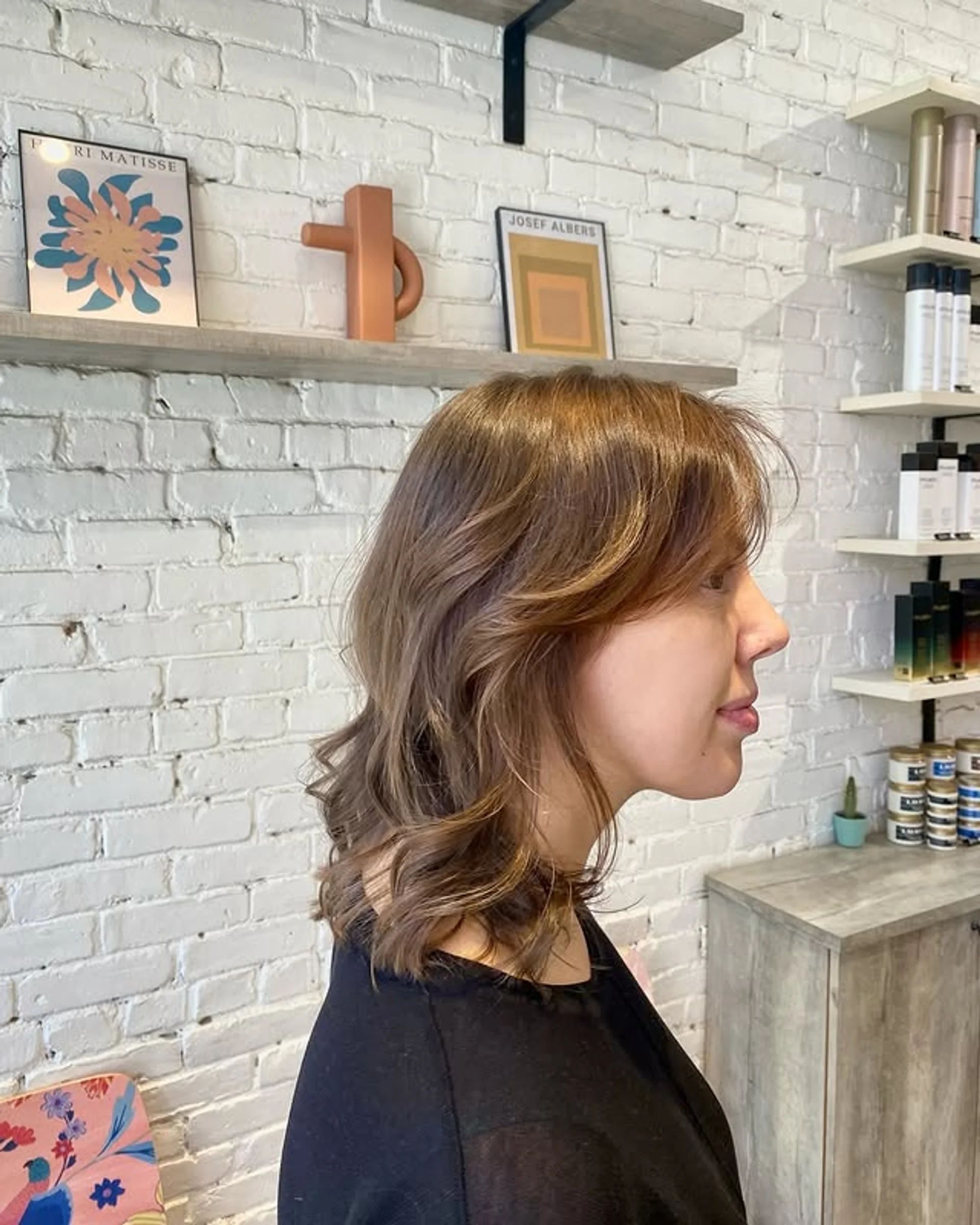 A man with medium-length wavy brown hair styled in a relaxed bro flow surfer hairstyle, demonstrating a key 2025 trend. - Preview 3