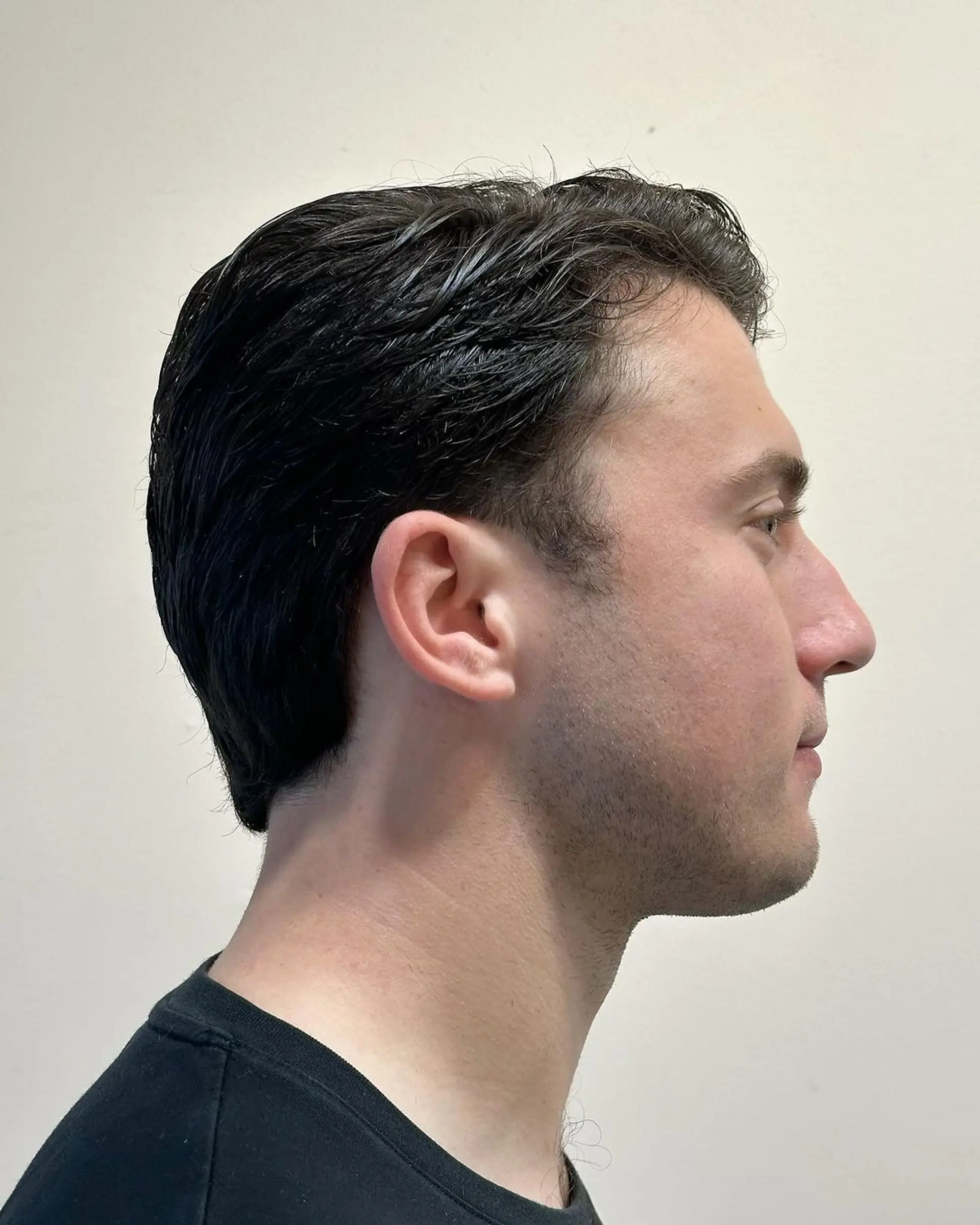 Sleek and polished side-swept style with a smooth finish and tapered sides. 1