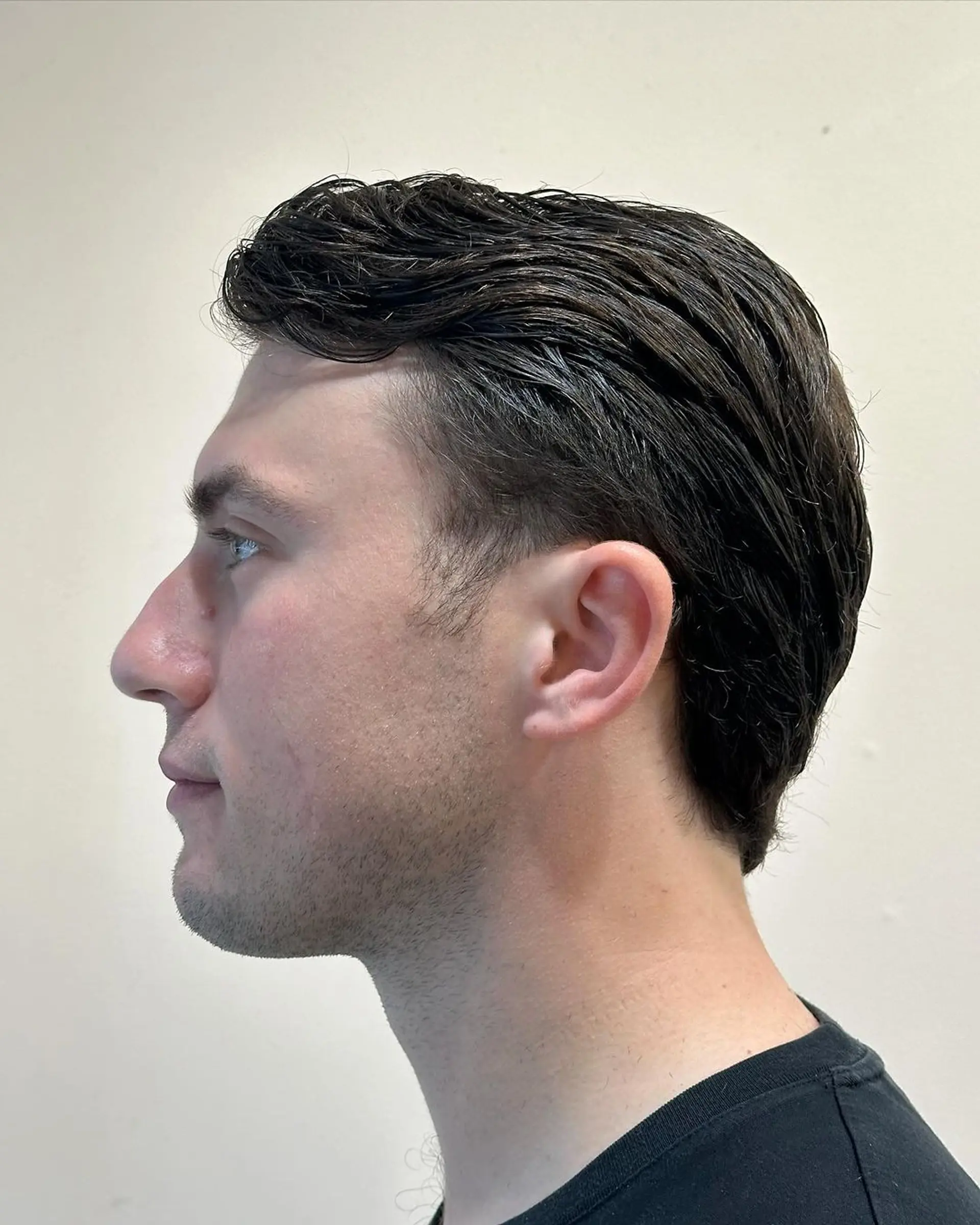 Sleek and polished side-swept style with a smooth finish and tapered sides. 2