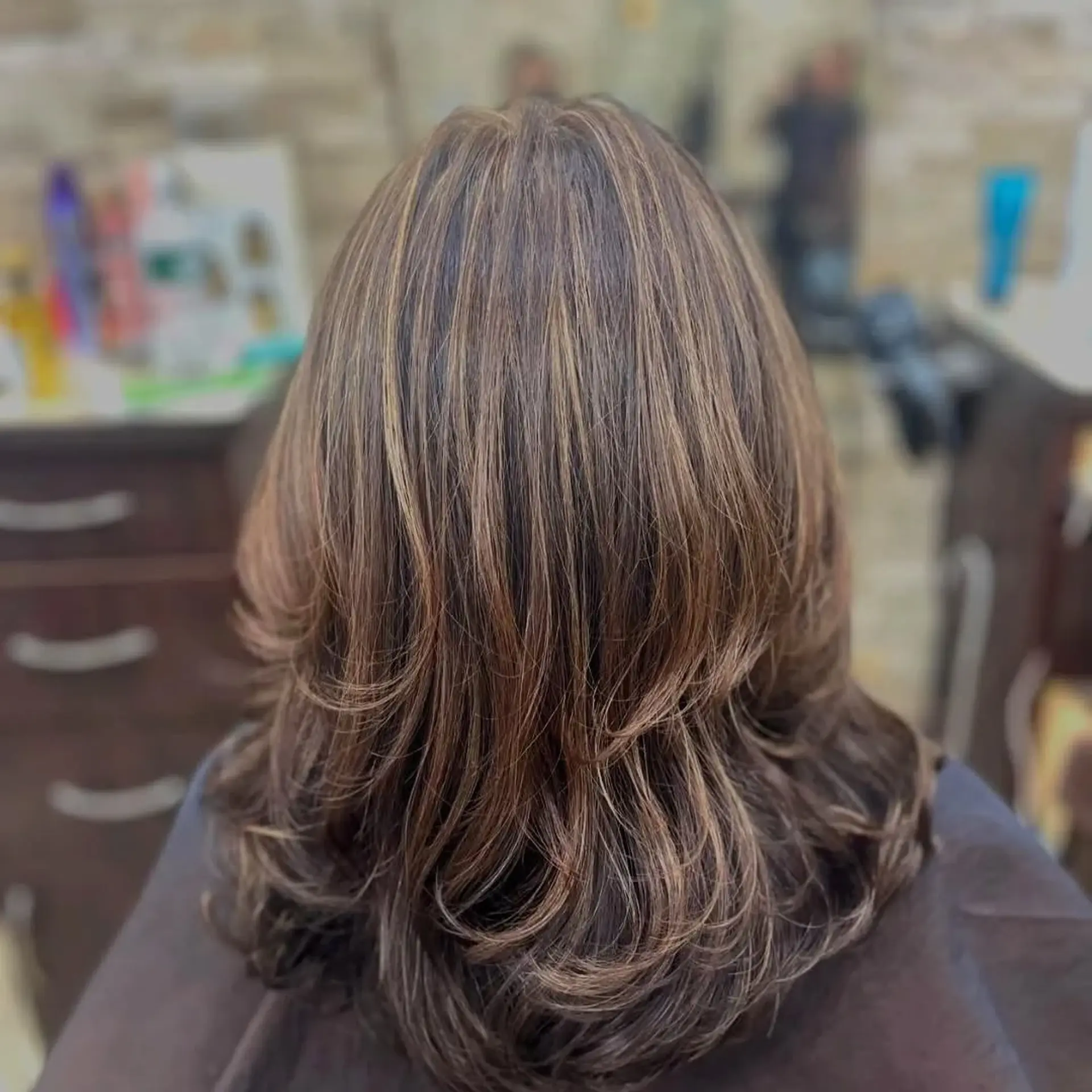 A medium layered bob with highlights and textured ends. 1