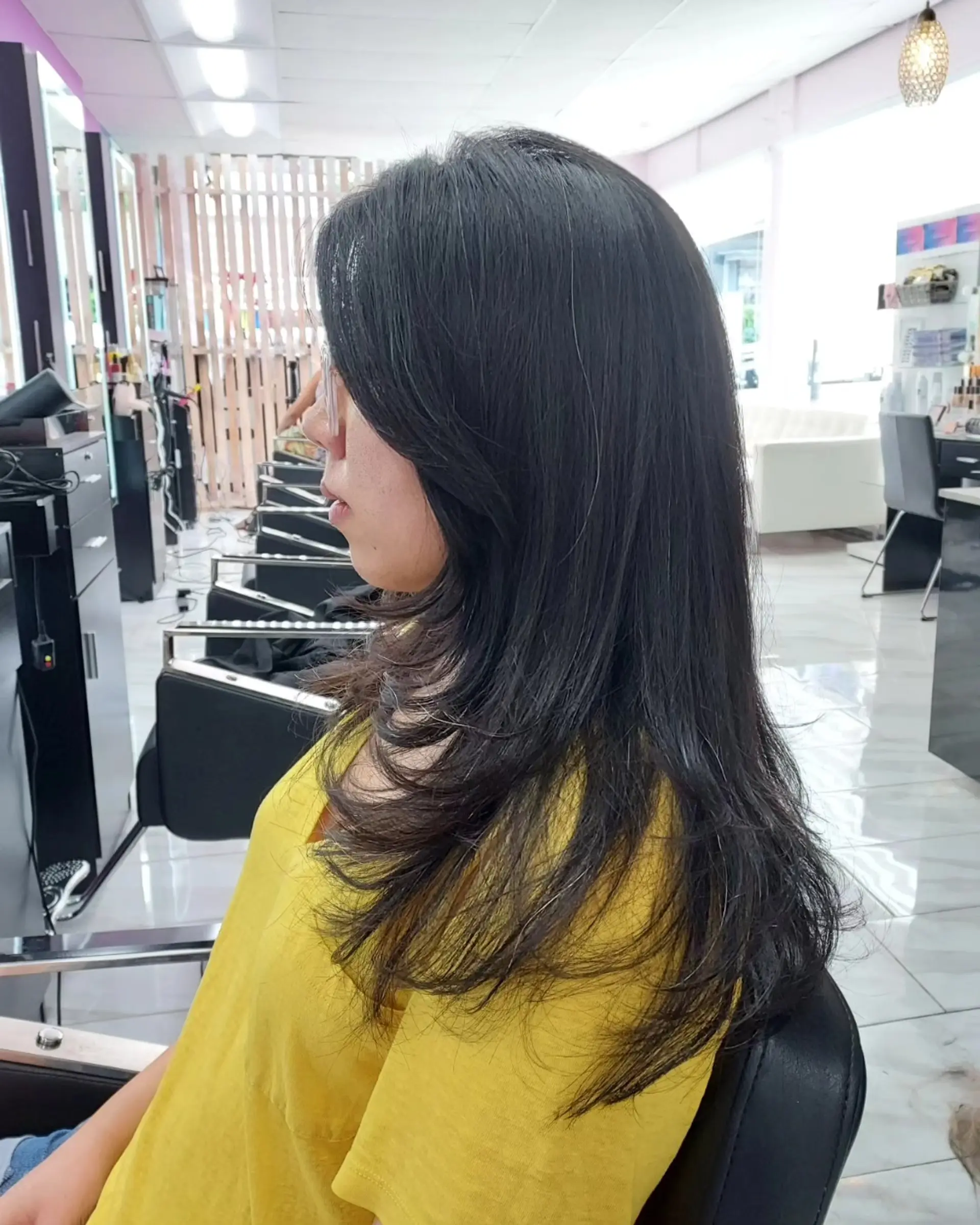A sleek, long layered haircut in natural dark hair featuring smooth face-framing layers and soft, curved ends. 1