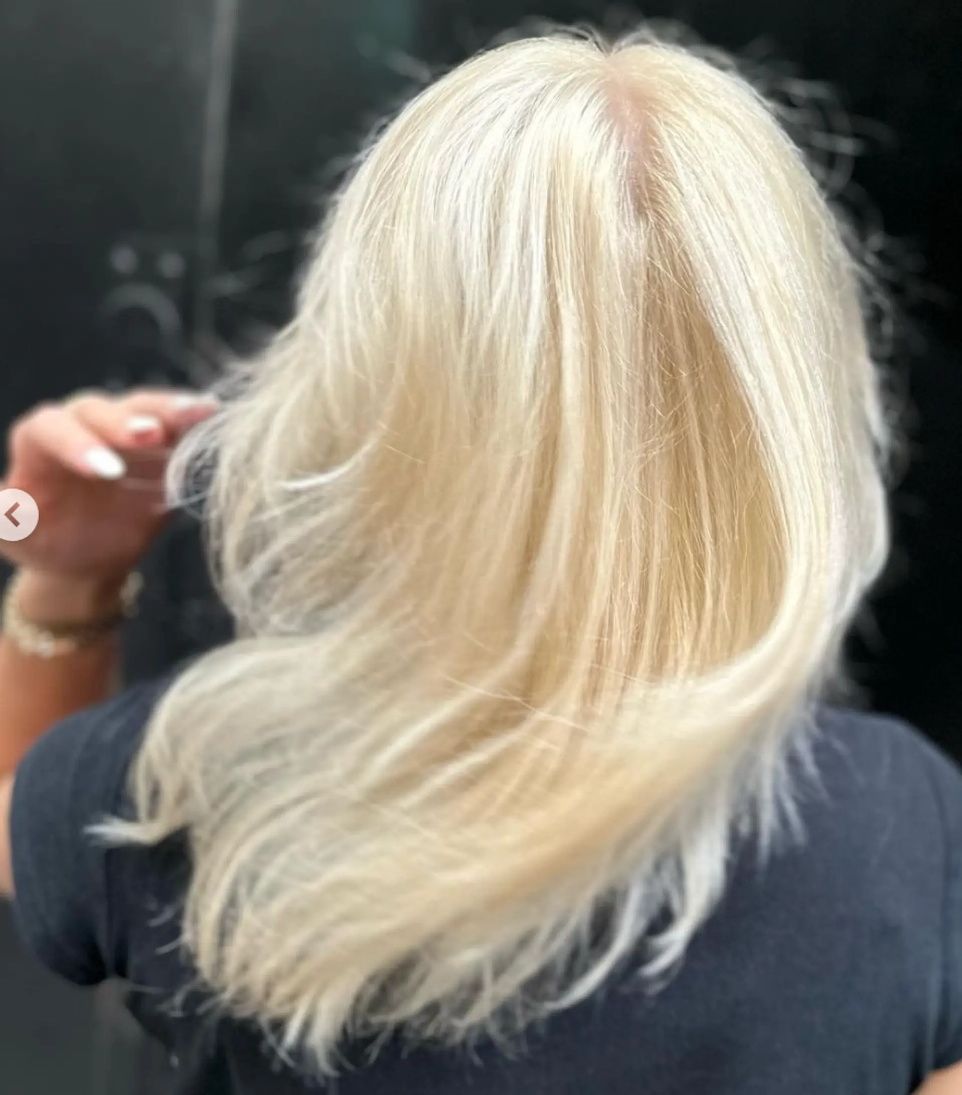 Medium-length, straight platinum blonde hair with a natural shine, casual waves, and feathered tips.

Color by @simabeautynyc
Cut and style by @juliamannino_hair
 1